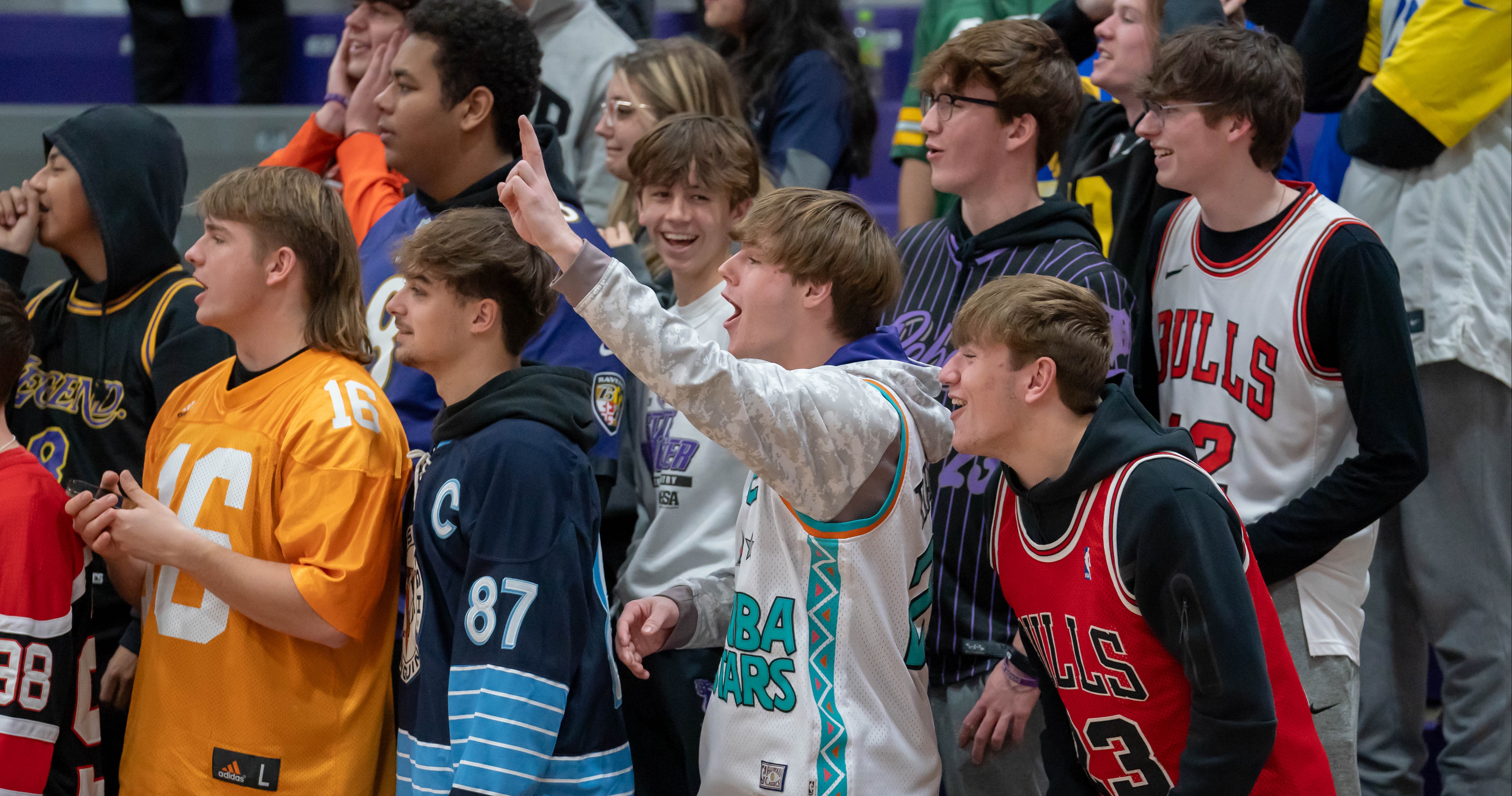 Students cheering on the boys varsity basketball team