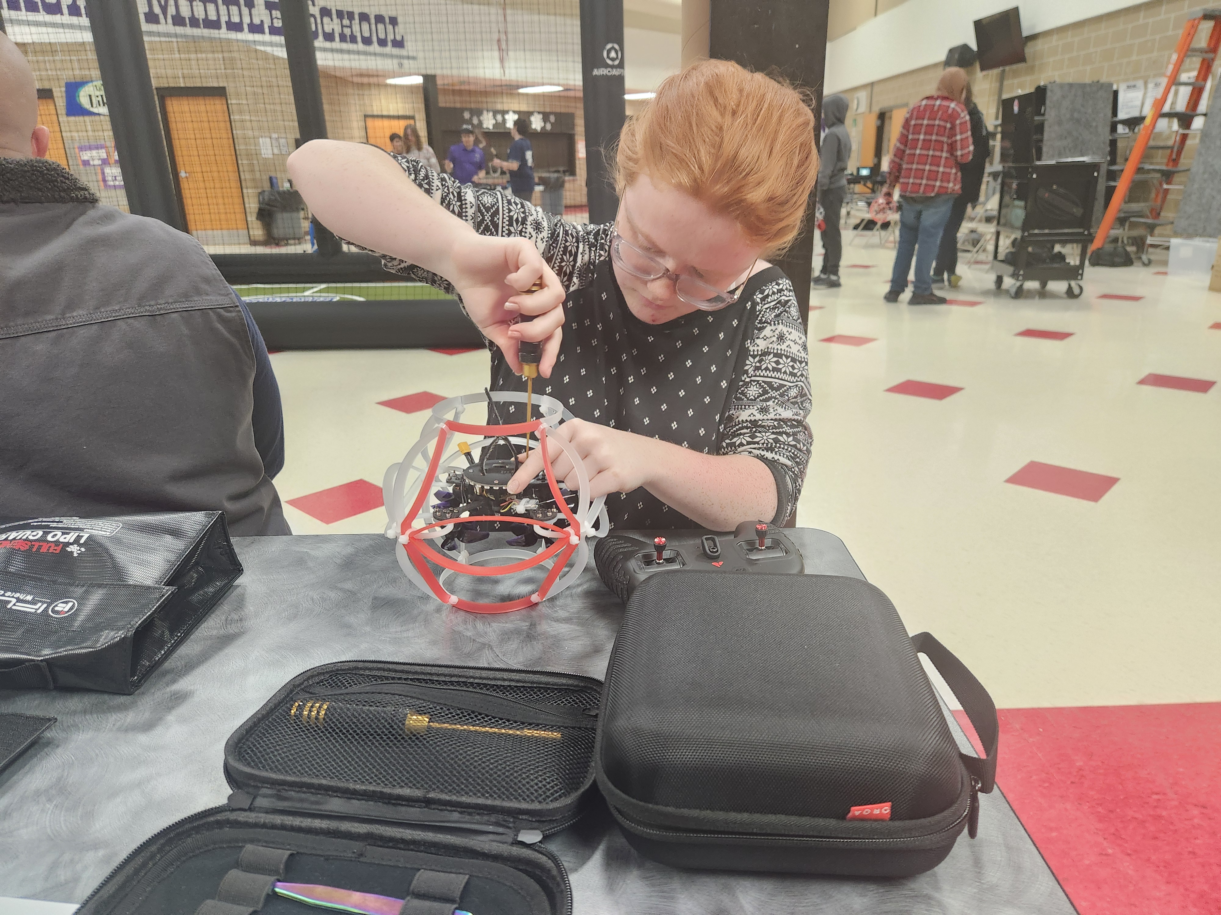 Photo of a student repairing a drone