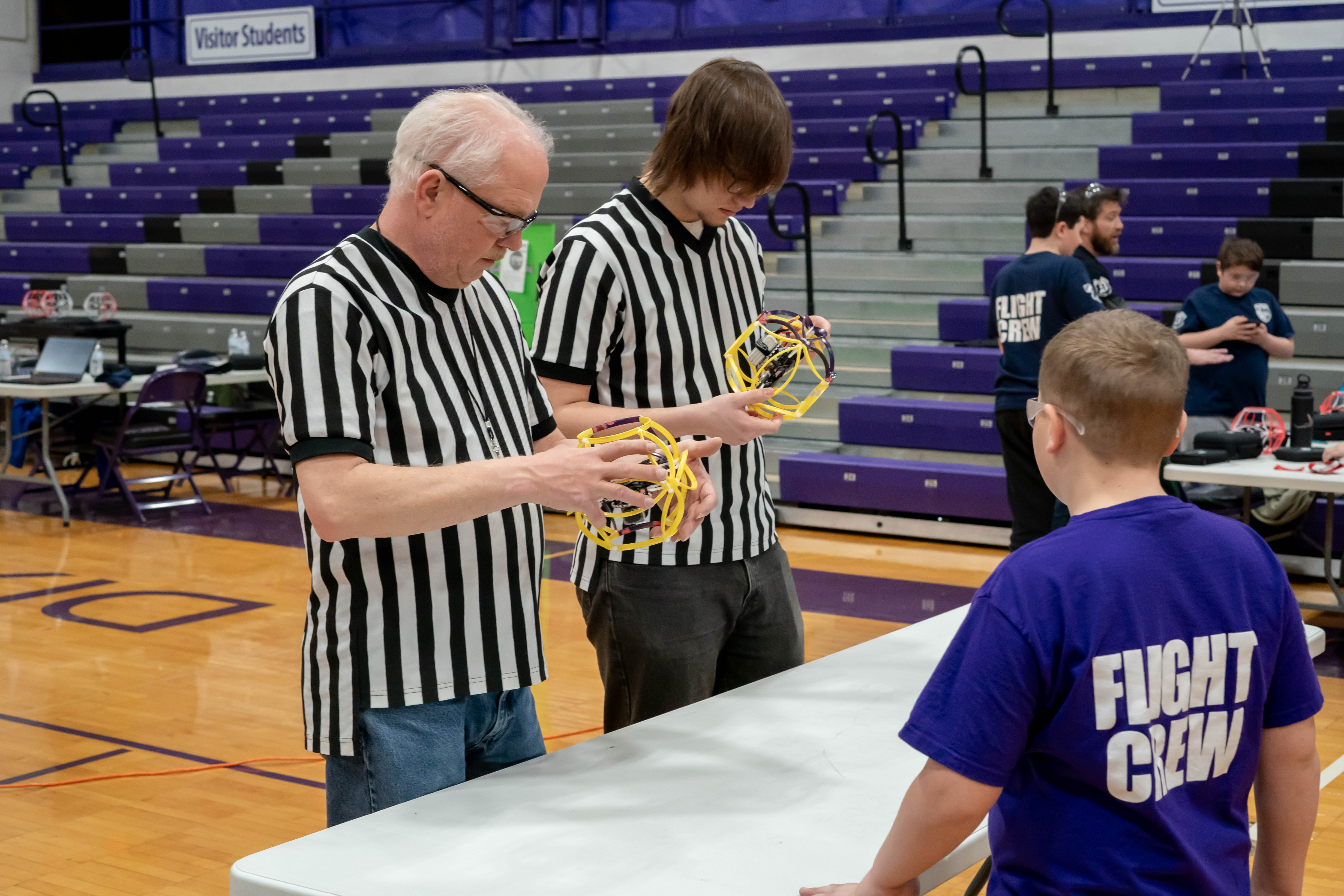 Photo of Refs inspecting drones