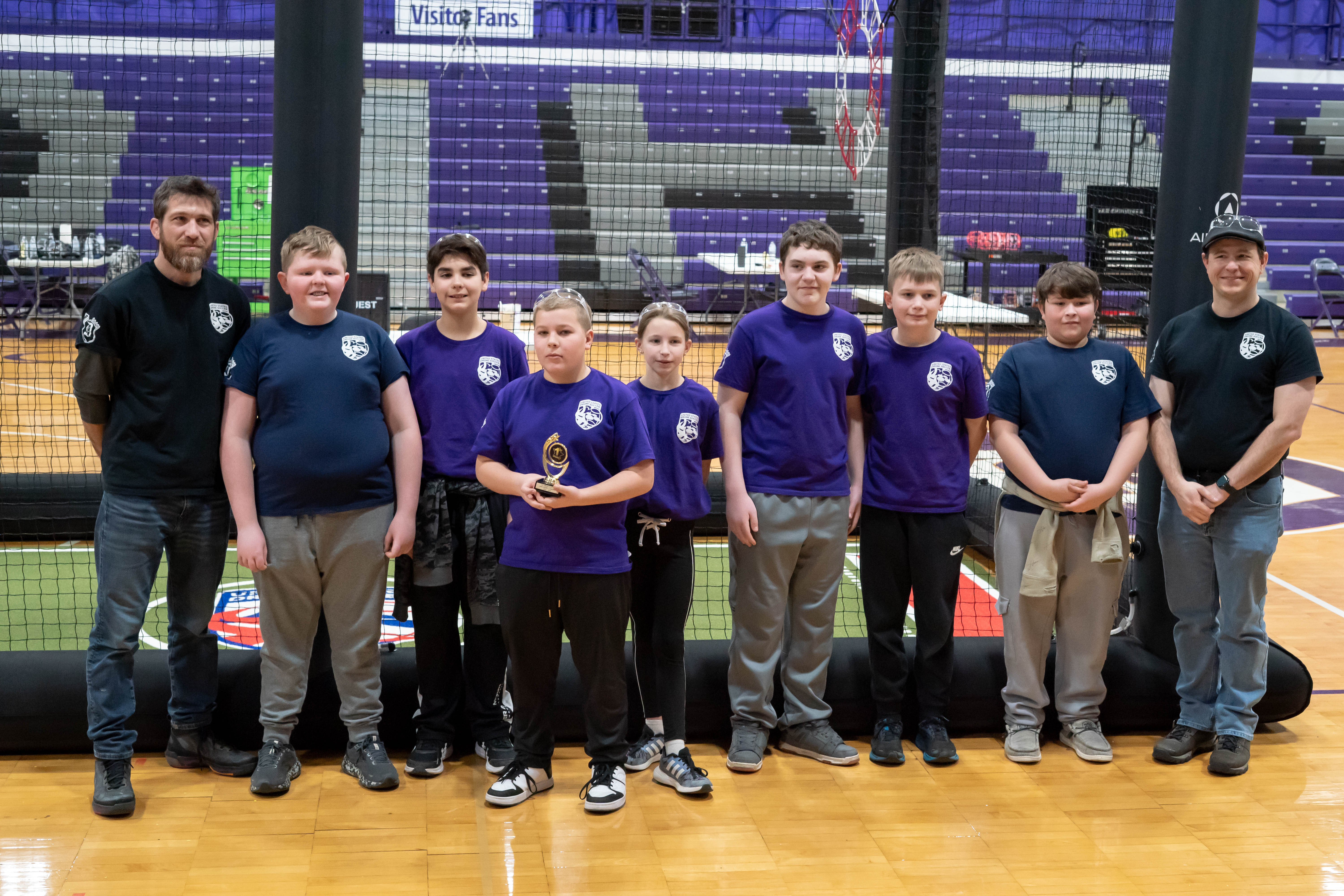 Photo of drone soccer team with trophy