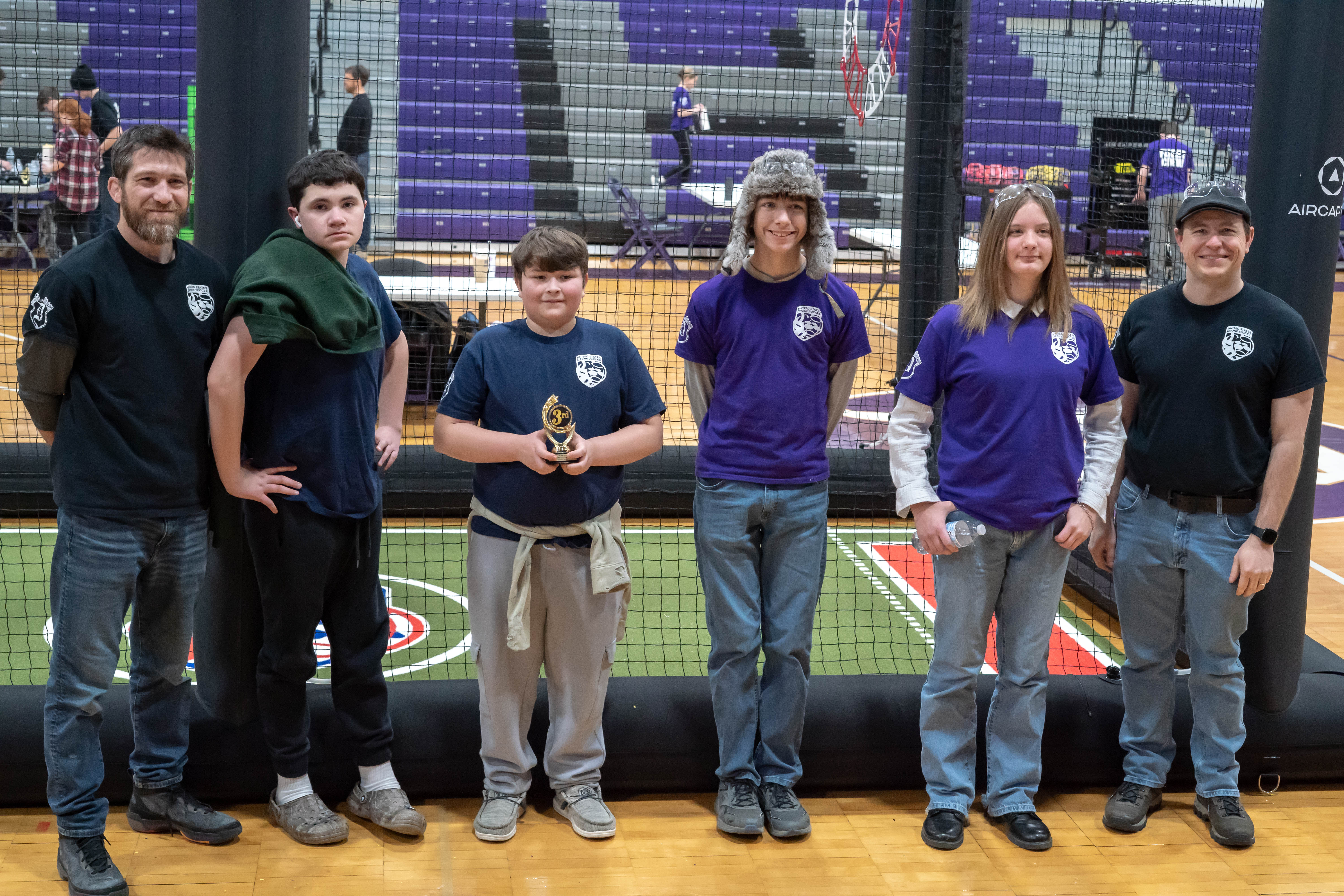 Photo of drone soccer team with trophy