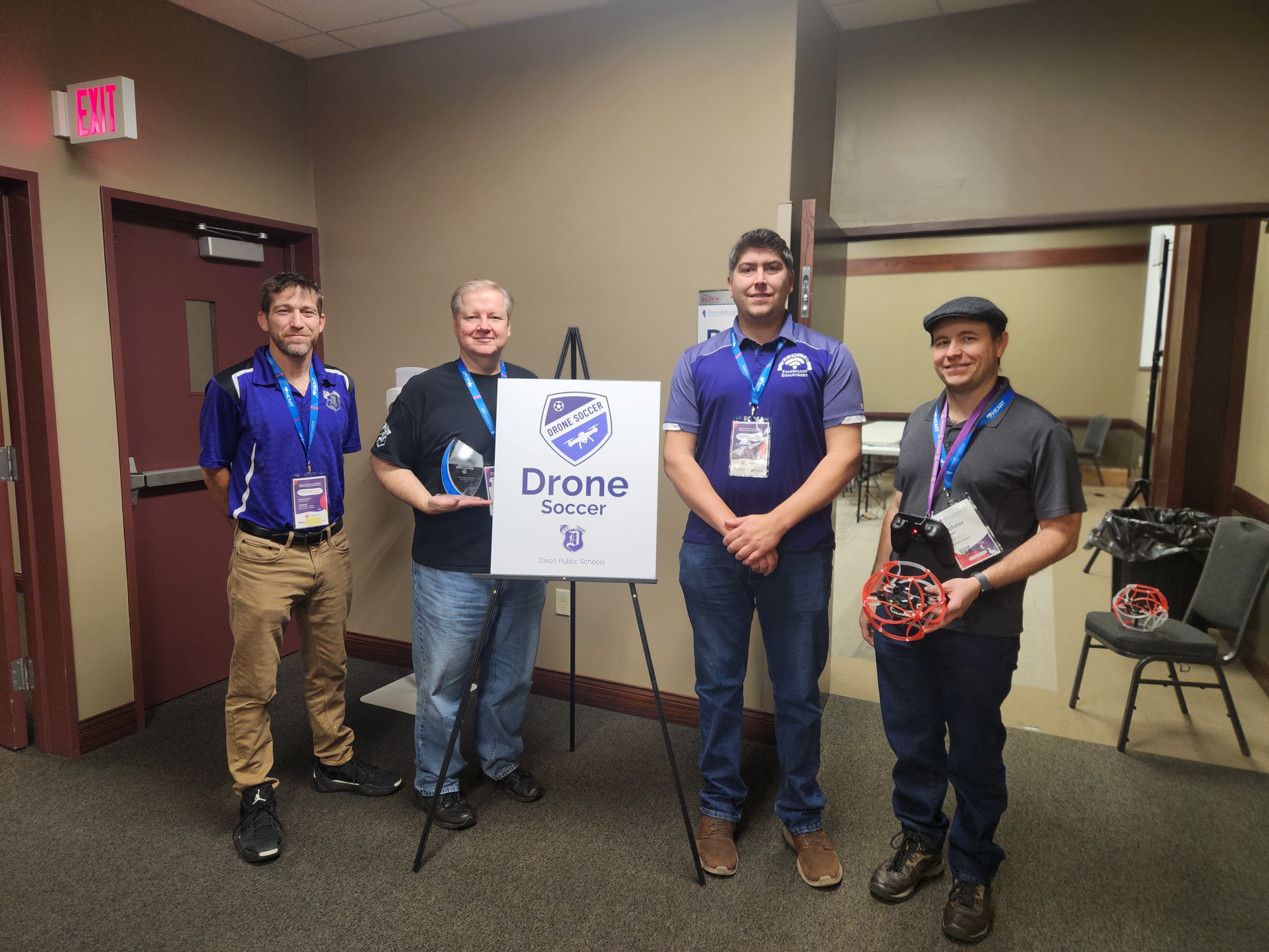 Photo of coaches with award