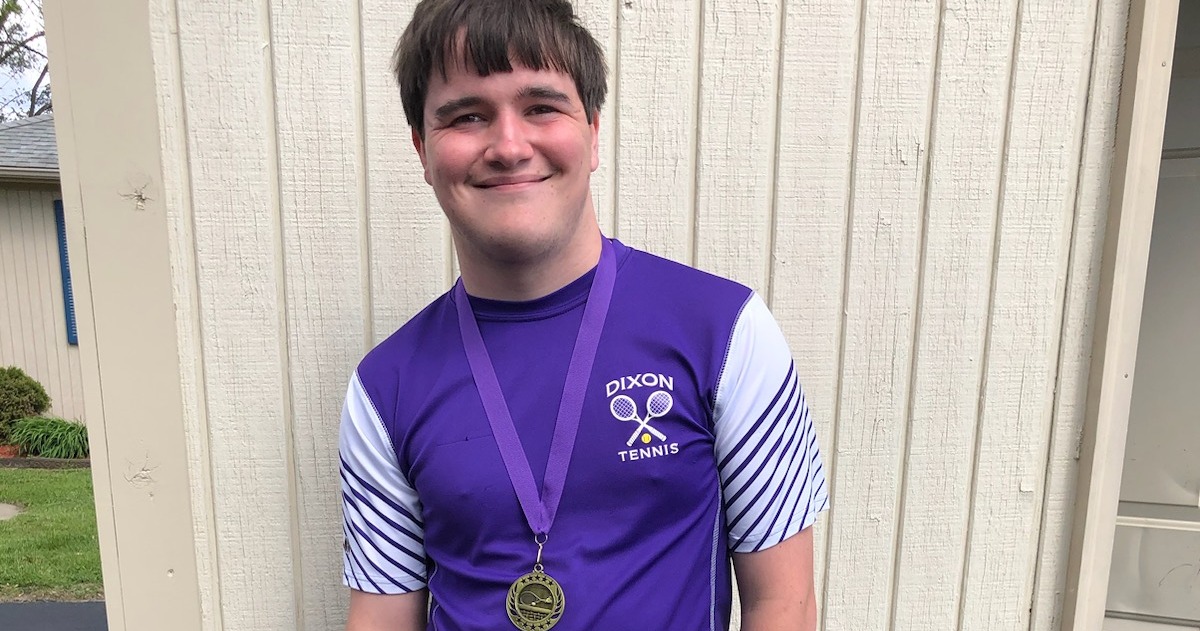 Sam Gingras with medal smiling for camera