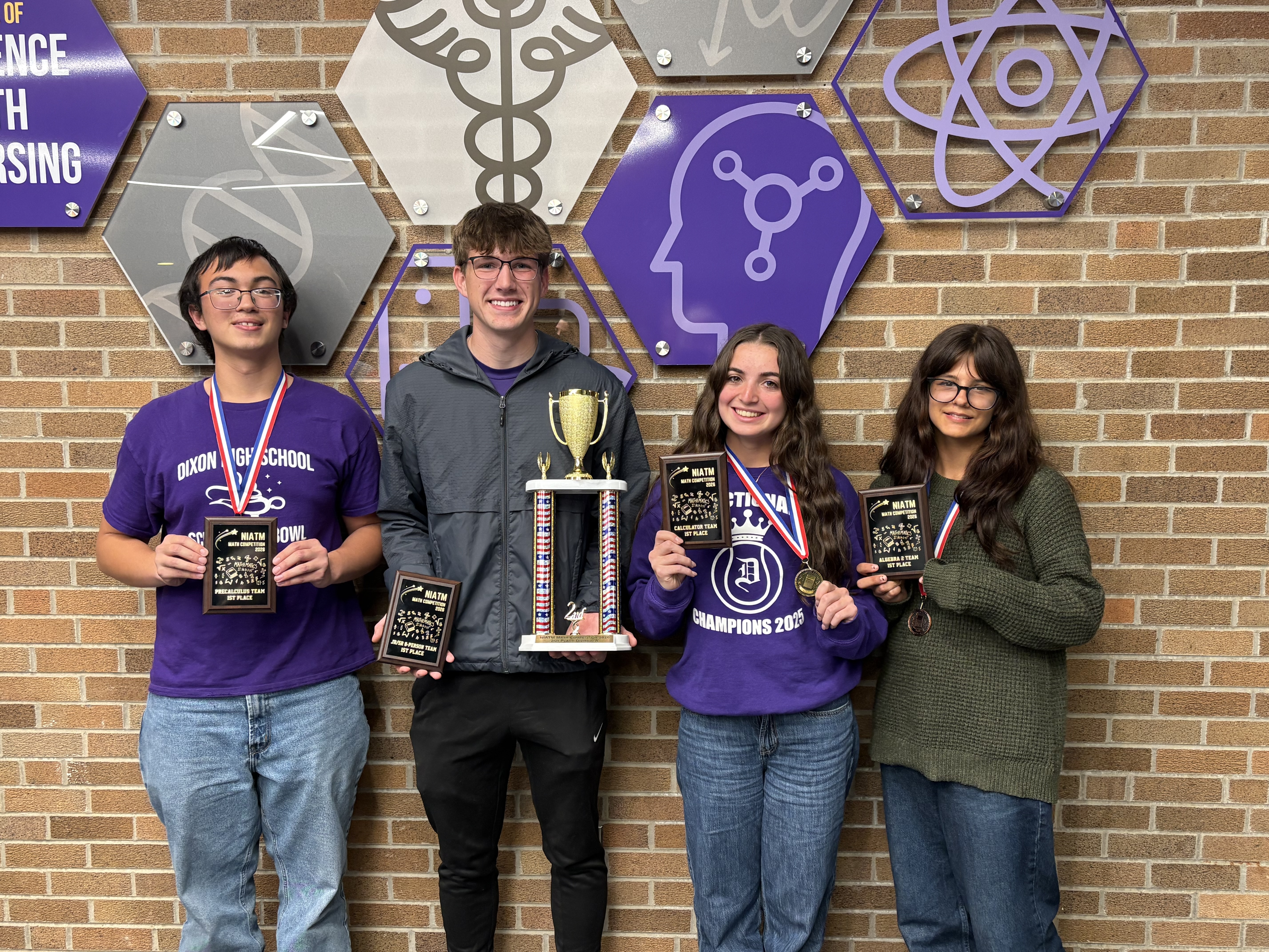 students holding trophies after winning math competition