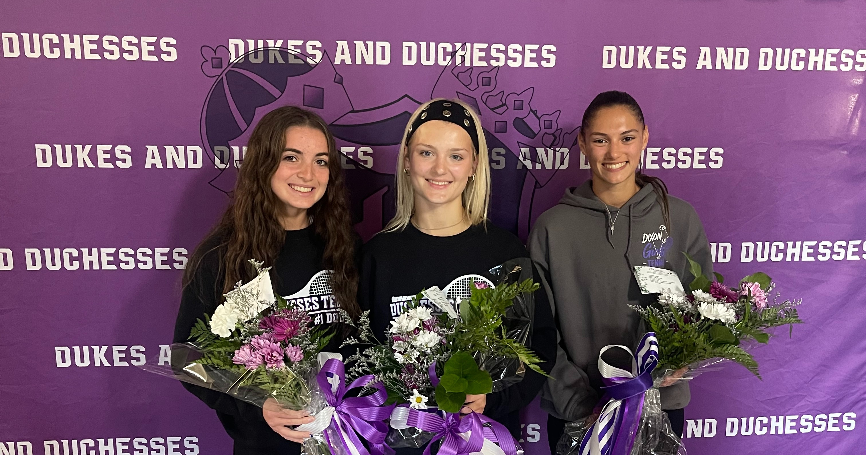 tennis players holding flowers