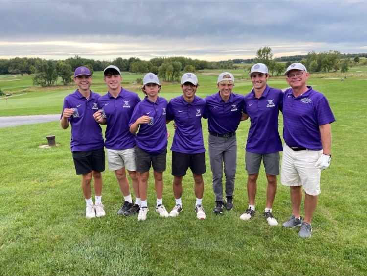 Photo of Coach Eastman and 6 golf players