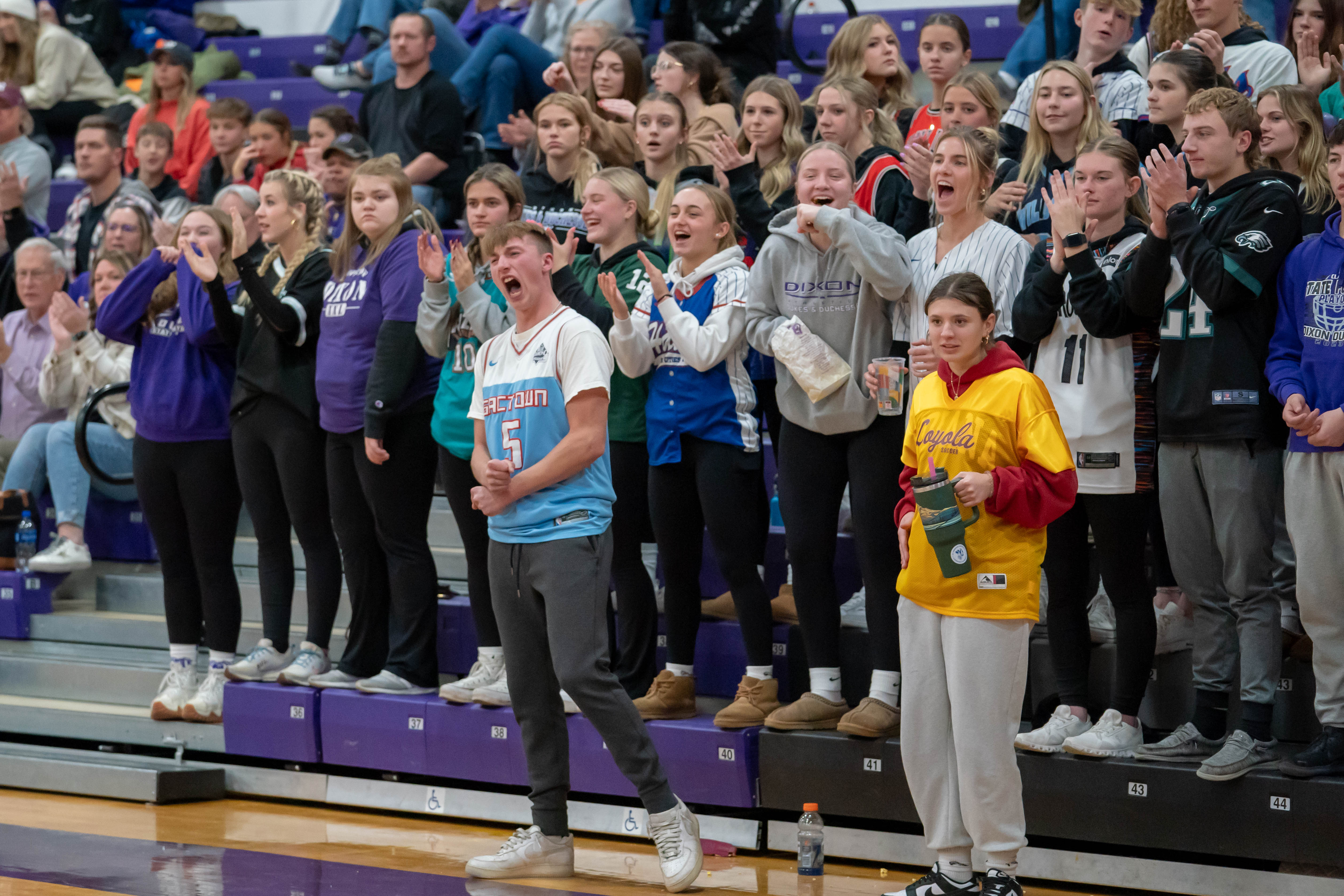 Students cheering on the Boys Varsity basketball team