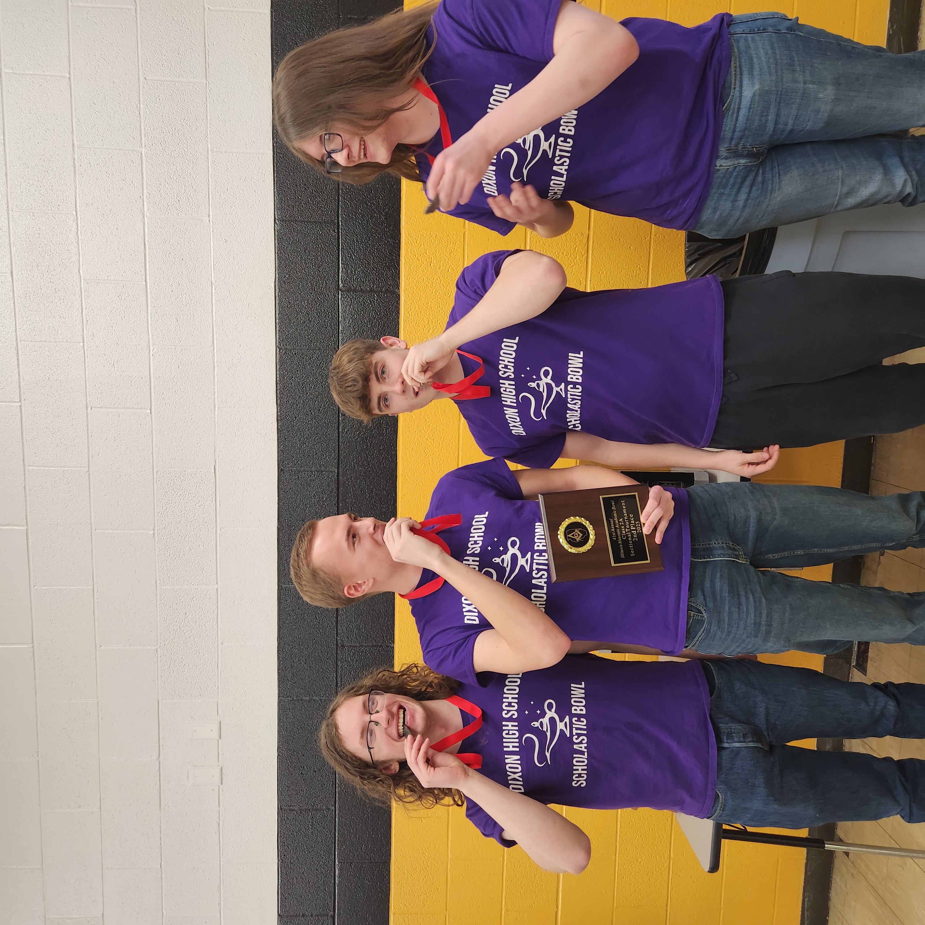 scholastic bowl winners holding awards