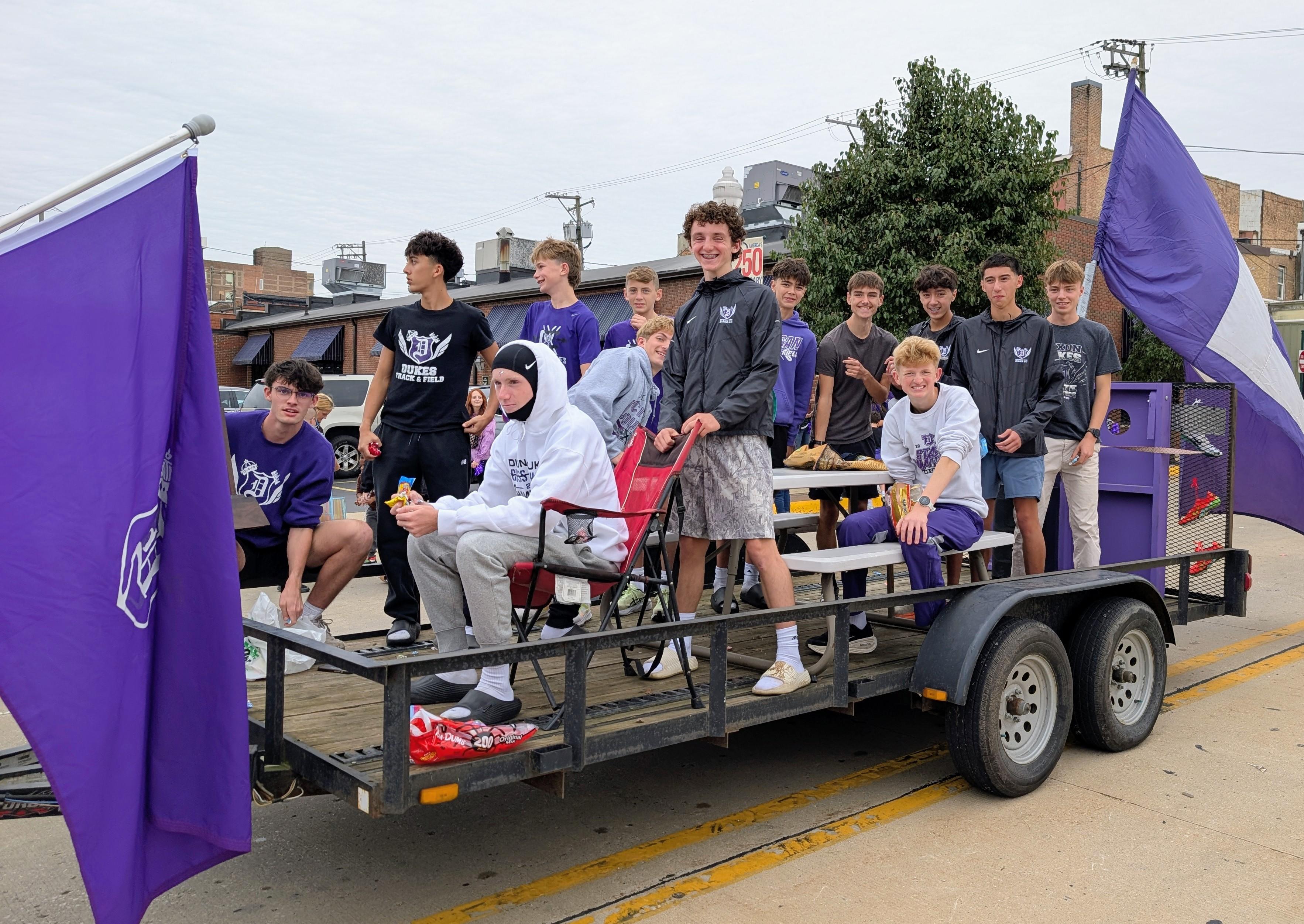 students riding homecoming float
