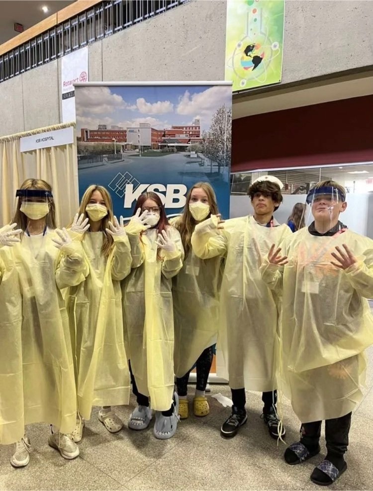 Middle School students at a career fair in medical gear