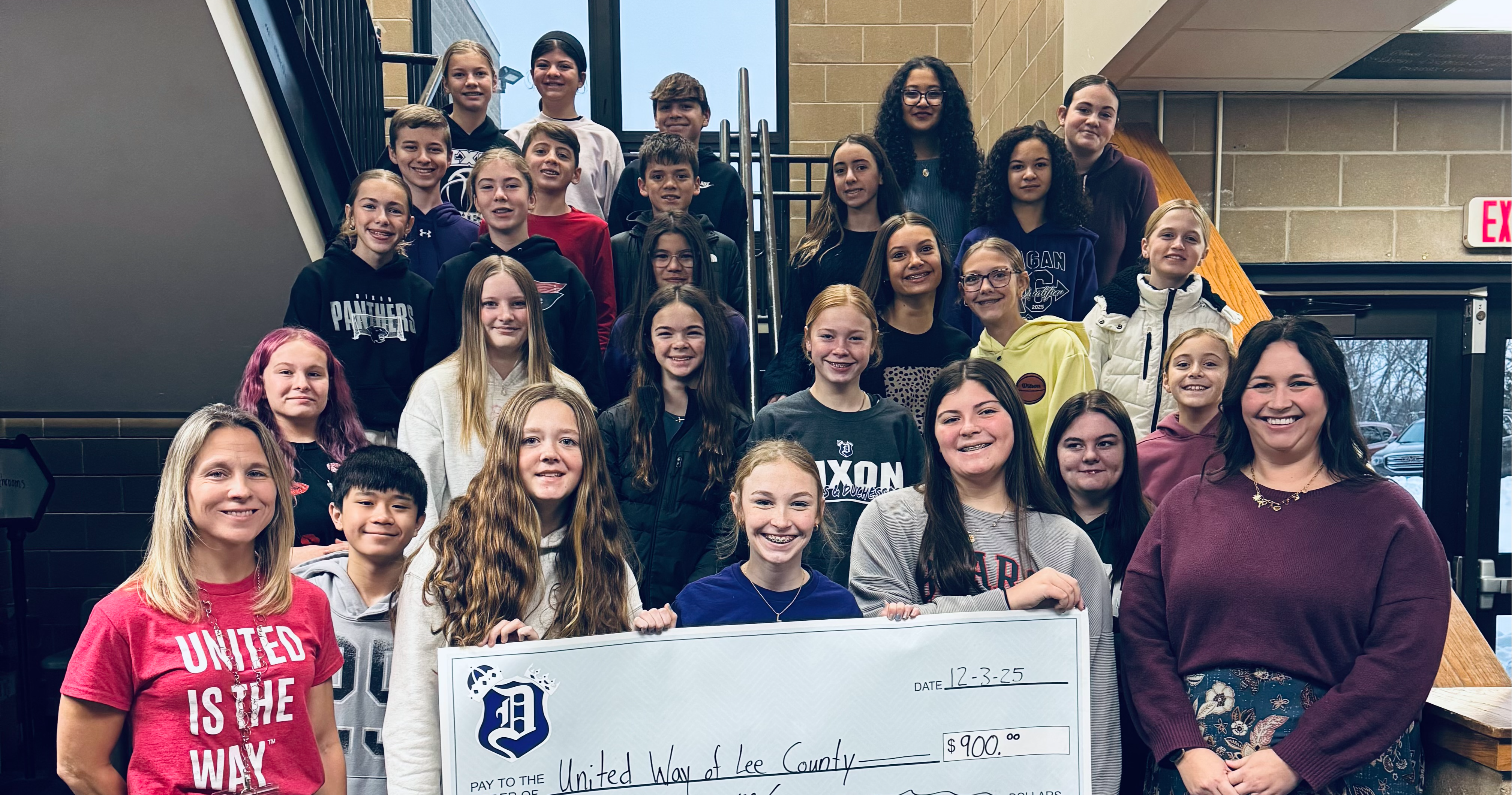 students holding big check