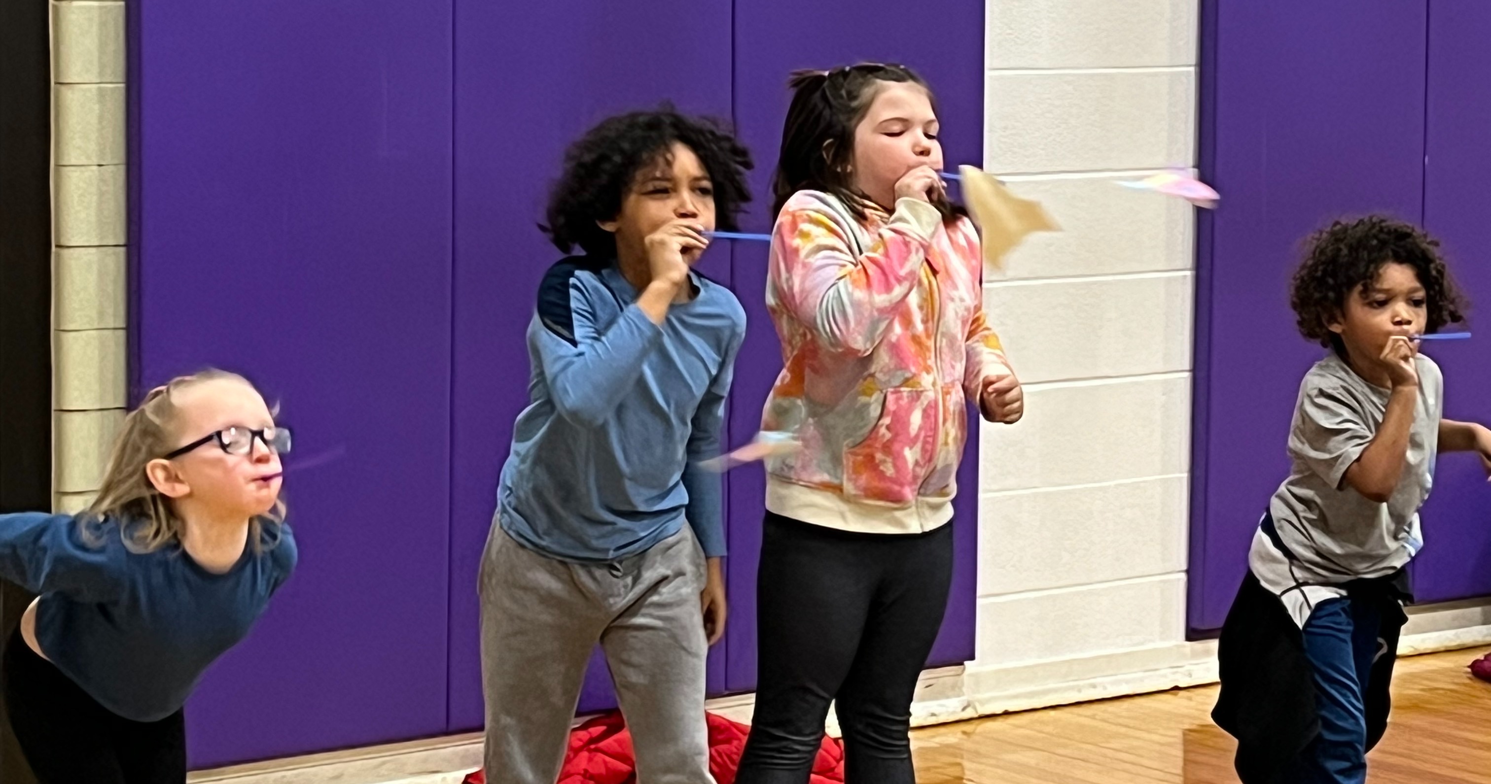 Students blowing into untensils at Jefferson School 