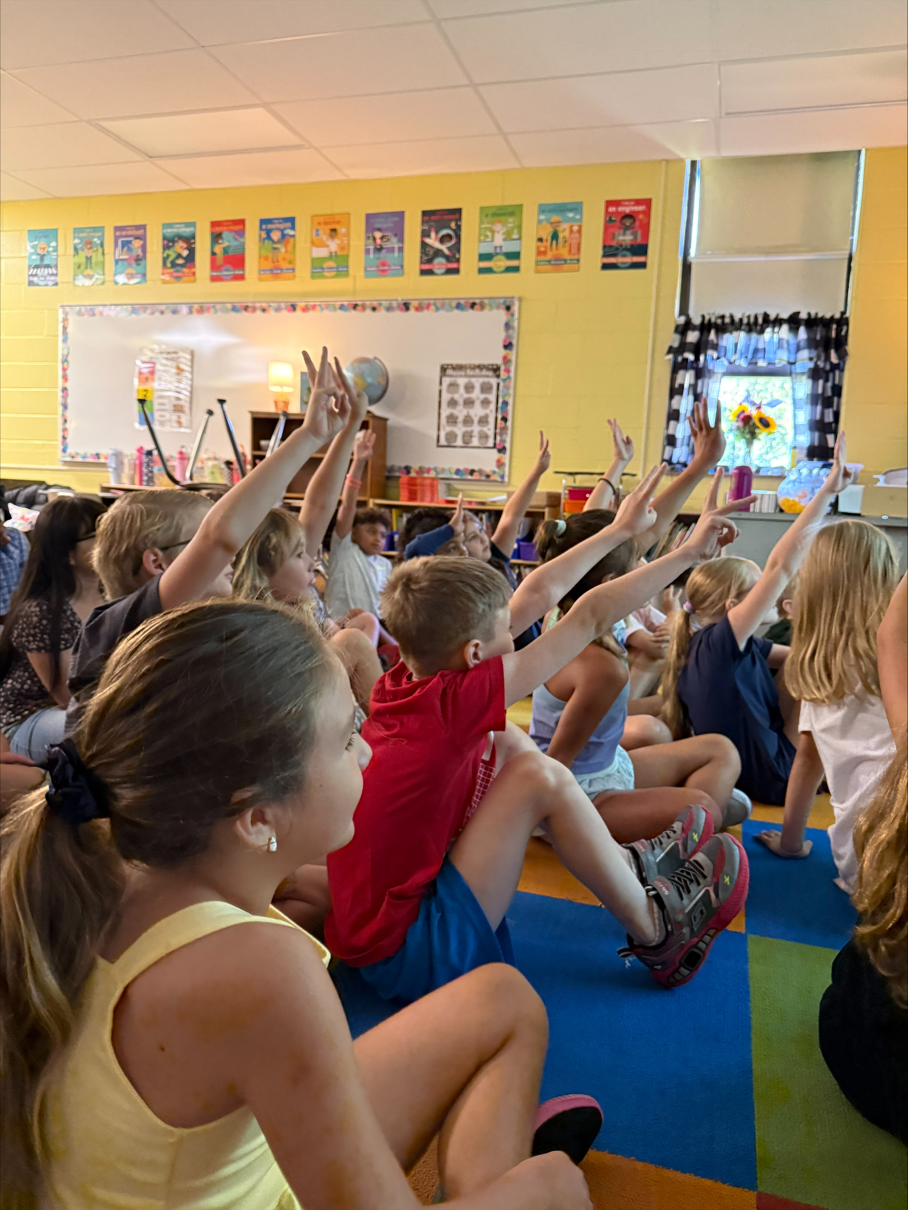students all raising their hands