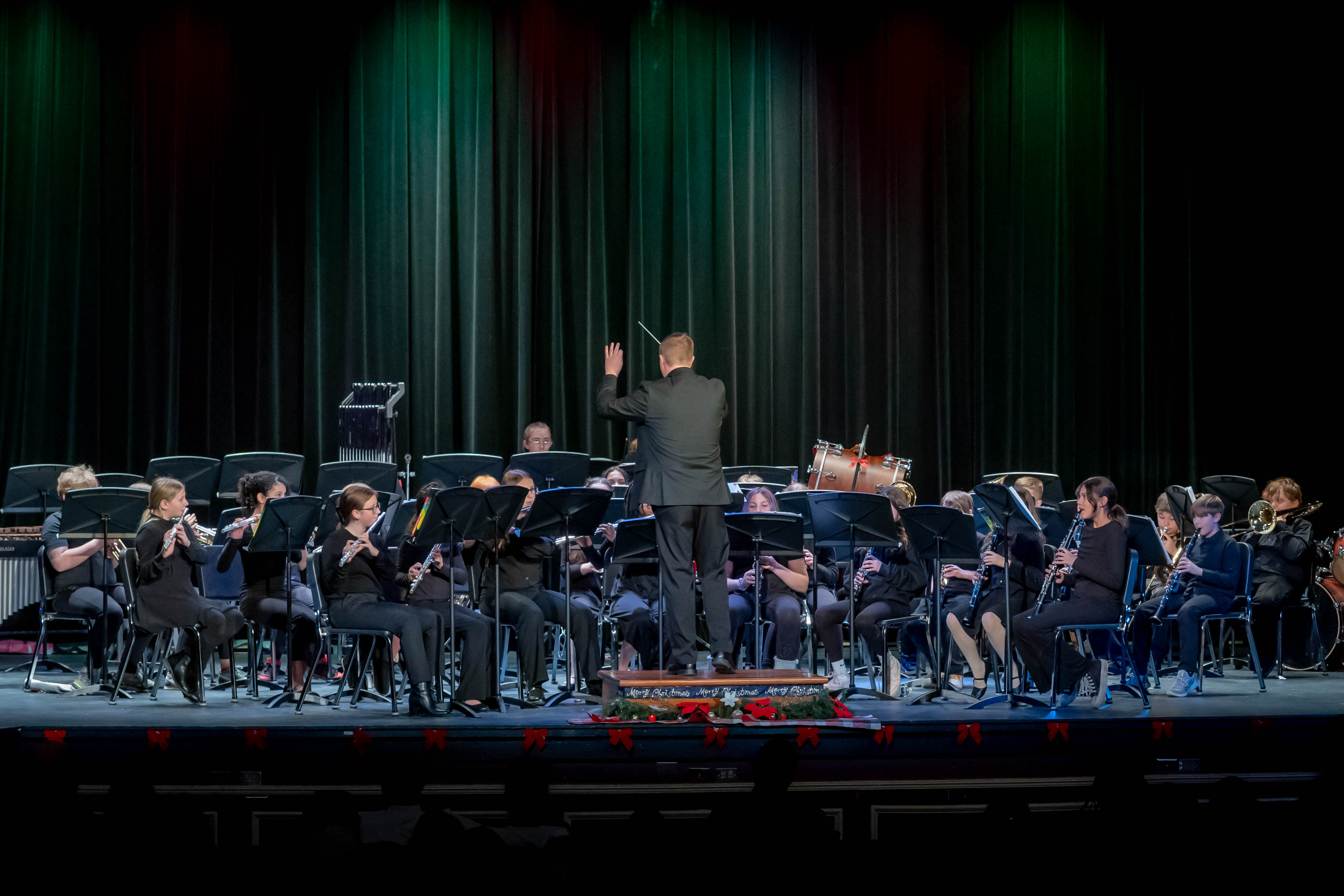 band teacher directing students at winter concert