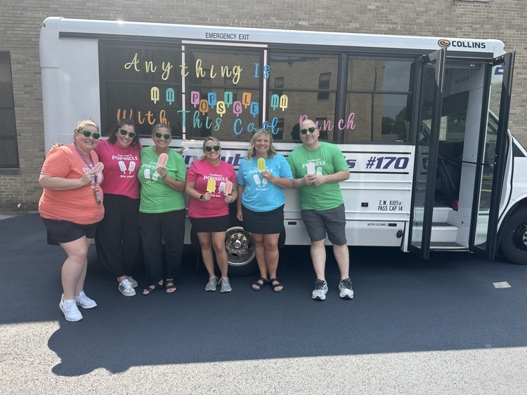 admins in front of bus holding ice pop