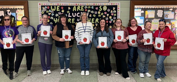 Madison paraprofessionals holding awards smiling at camera