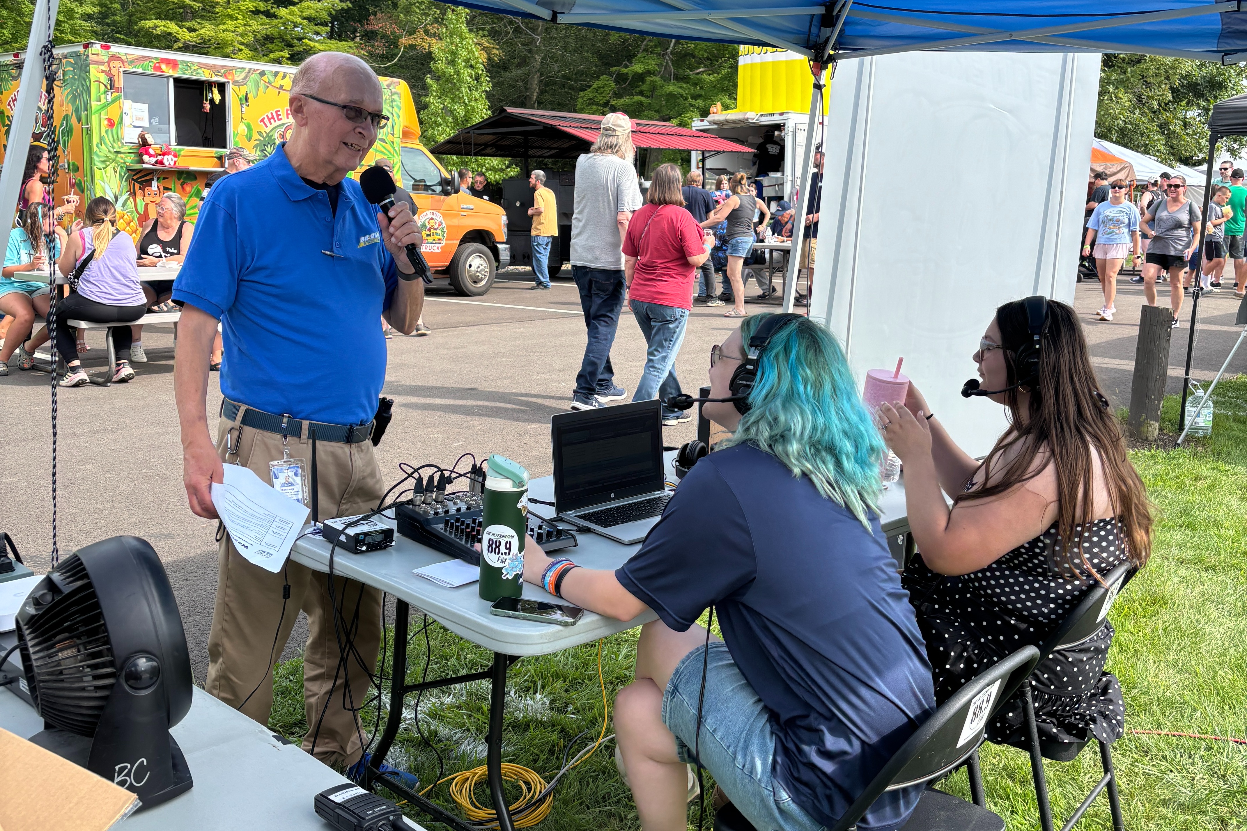 Bob Long doing weather break with students at a remote broadcast event