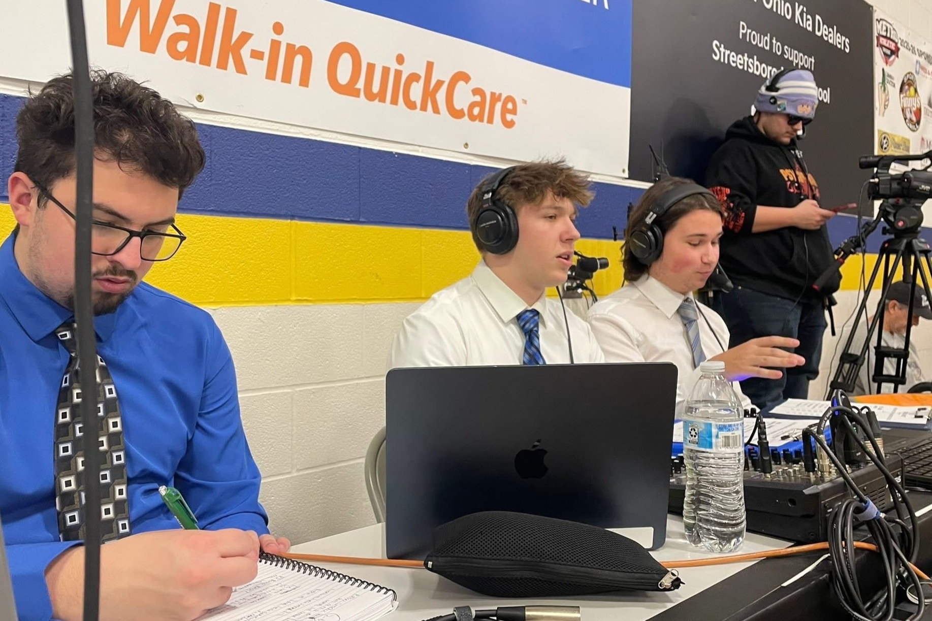 Students commentating and camera operating basketball game