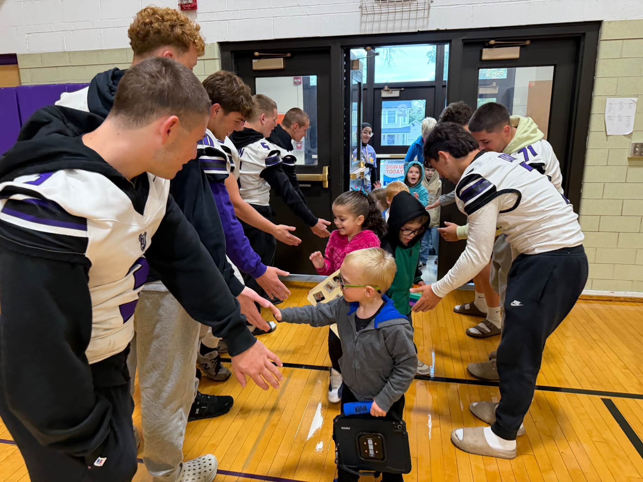 Washington students smiling with football players