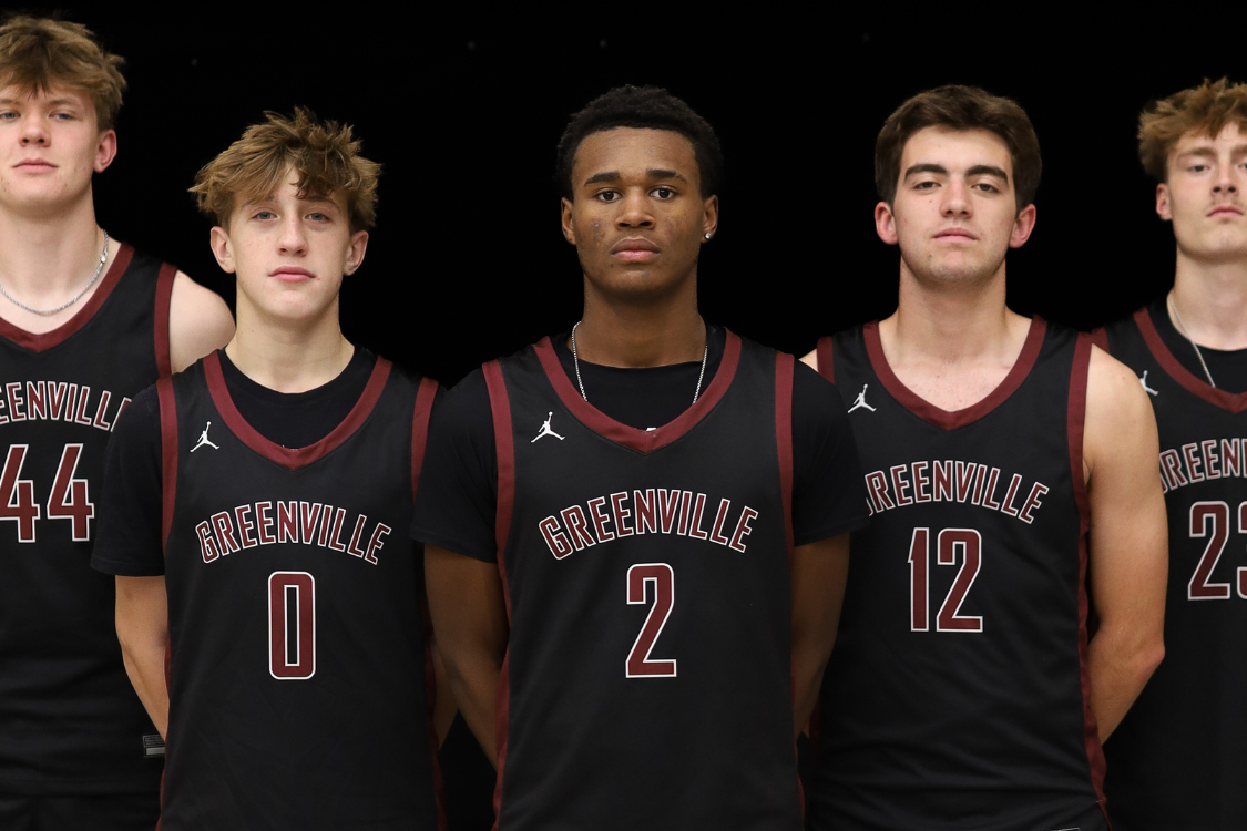 Five men wearing basketball jerseys with Greenville printed in white letters, numbers 44, 0, 2, 12, and 23.