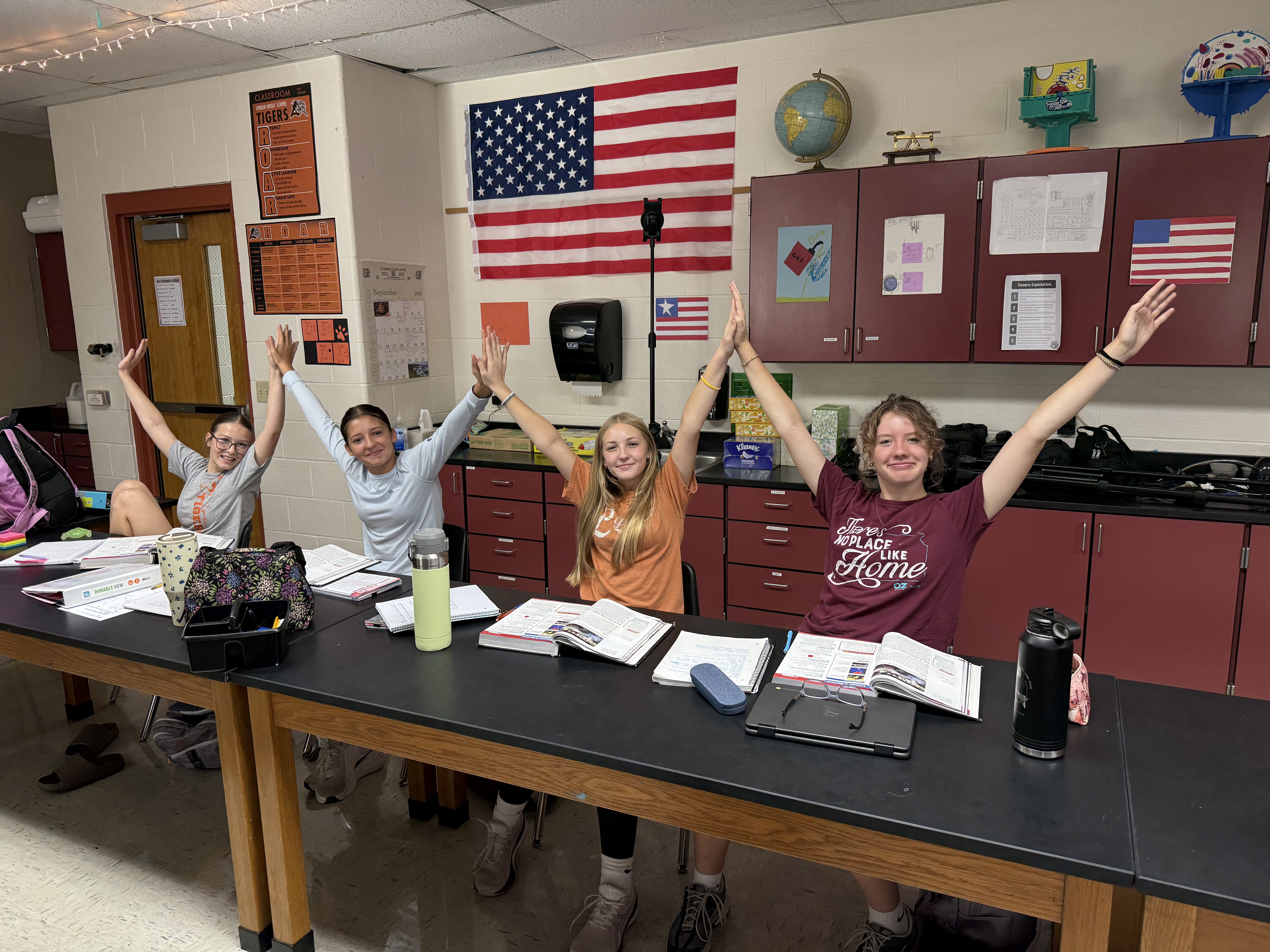 students touching hands in classroom
