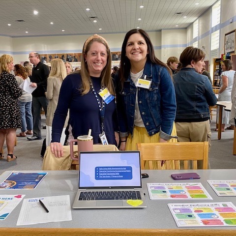 Two teachers smiling as they present at Collegial Cafe