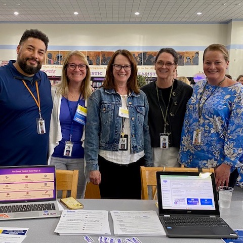 Groups of teachers smiling as they present their research