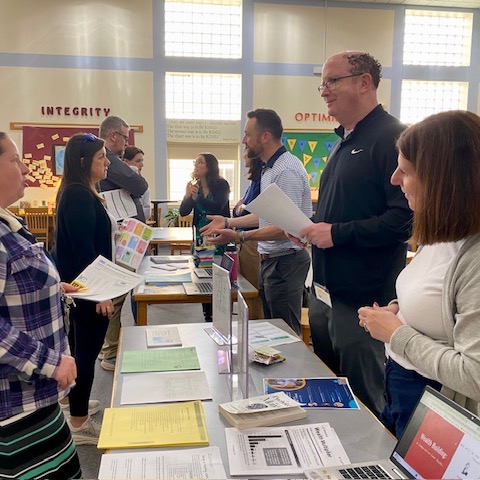 Teachers talking to other teachers at collegial cafe