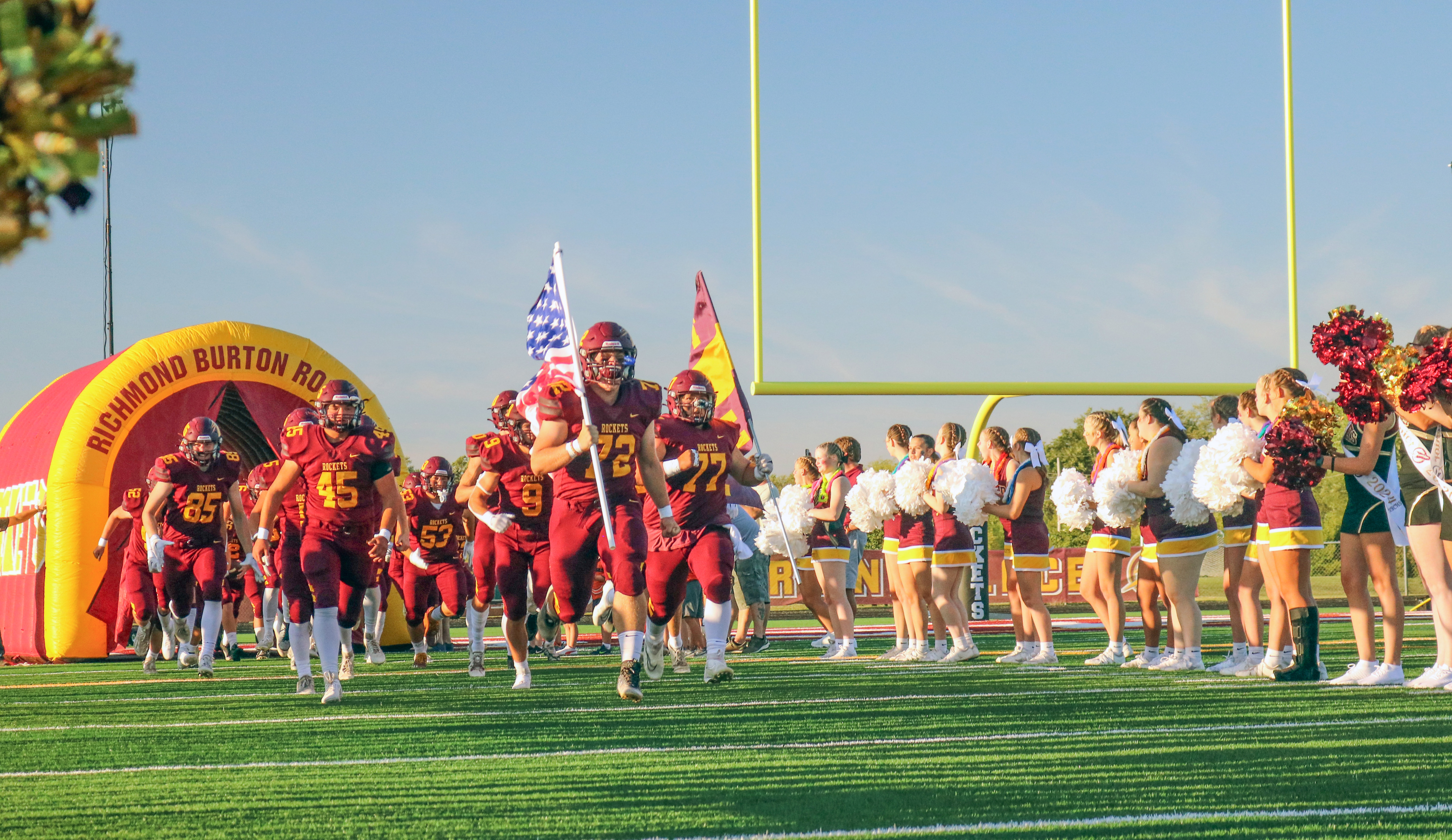 RB Football team rallying onto the field with cheers