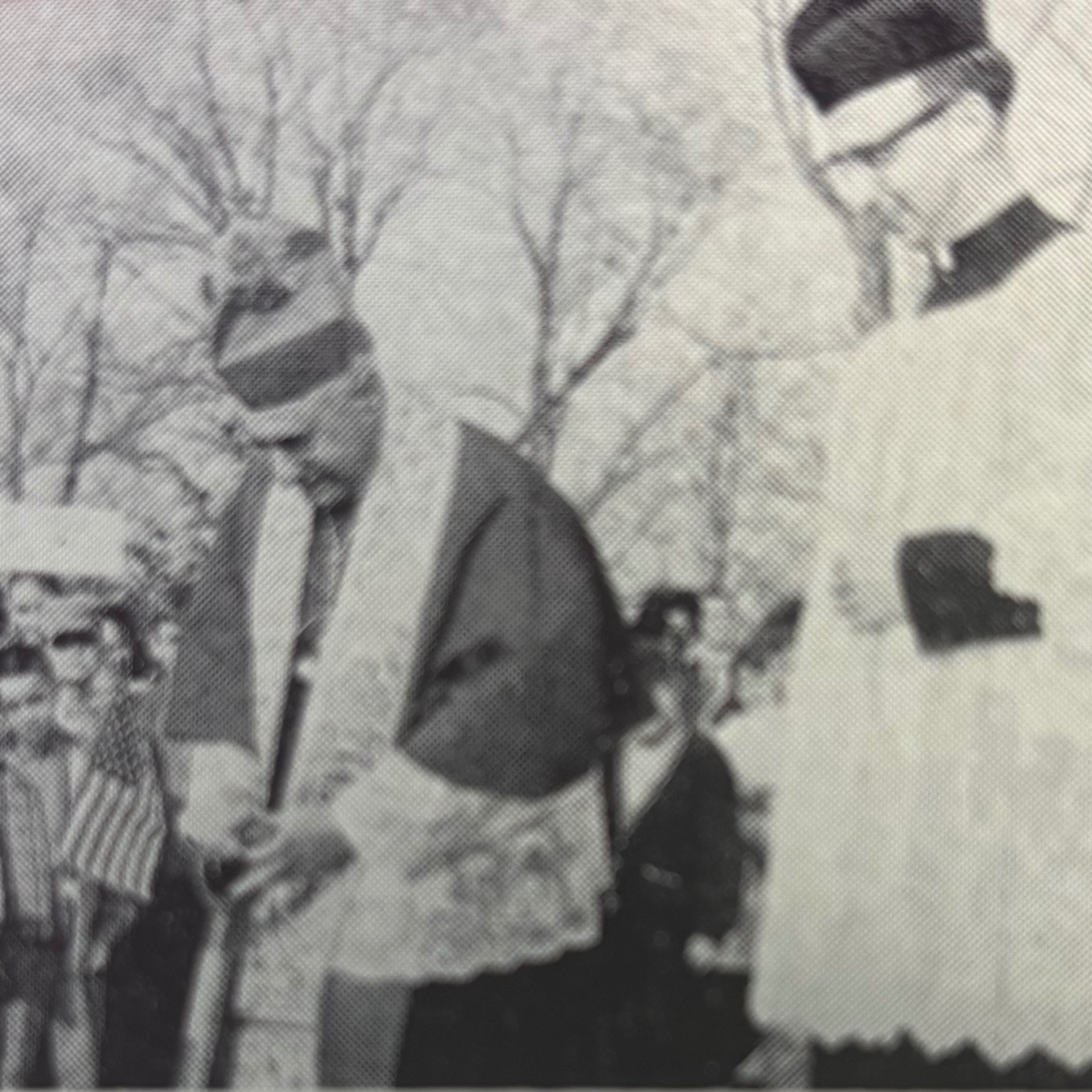 An old book page with a black-and-white photo of people in traditional clothing attending a ground-breaking ceremony.