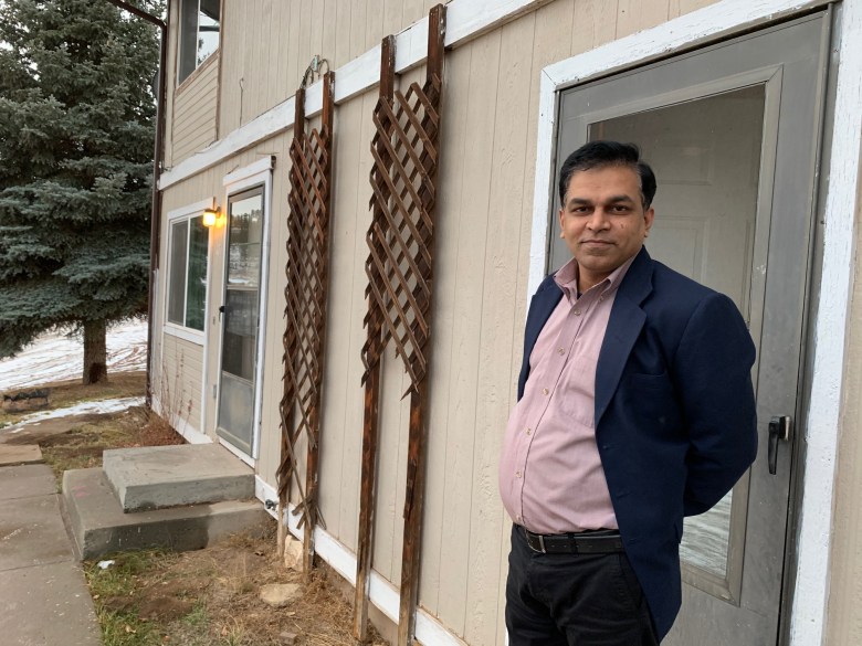 math teacher stands outside classroom