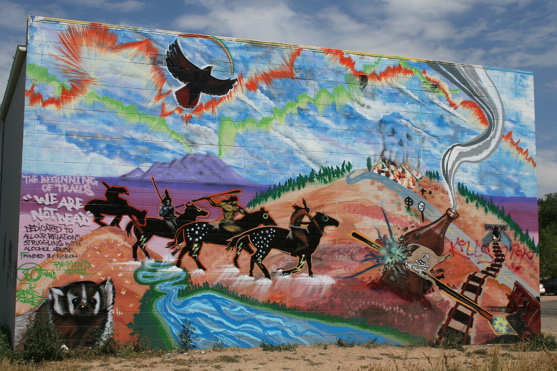 community-created mural of riding crossing steam and text inspiring community to assist those fighting addiction