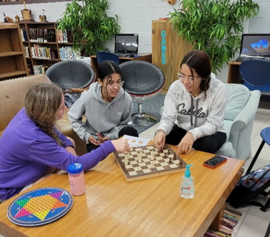 Students playing chess in the LHS library