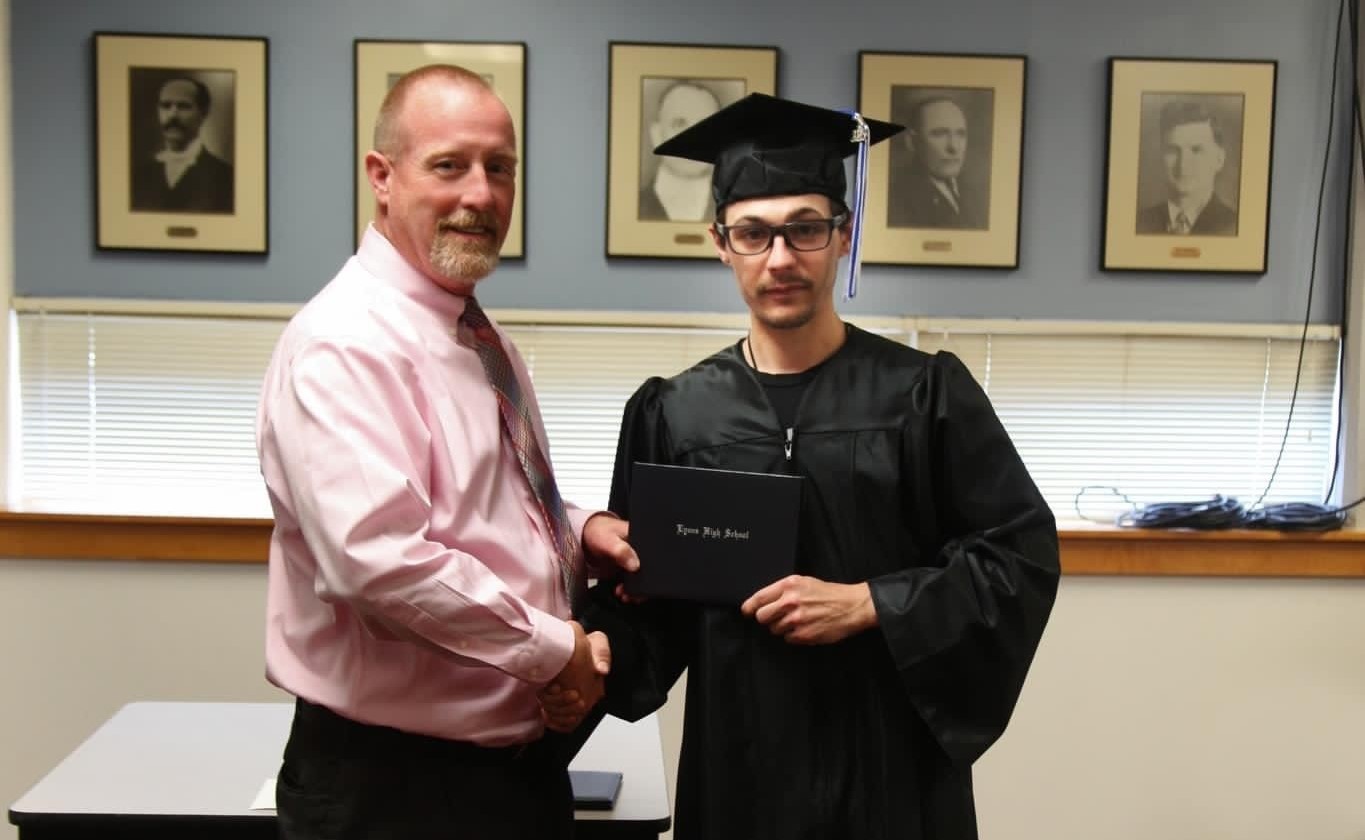 Mr. Ashmore delivering diploma to 2023 Graduate Wyatt Fistler