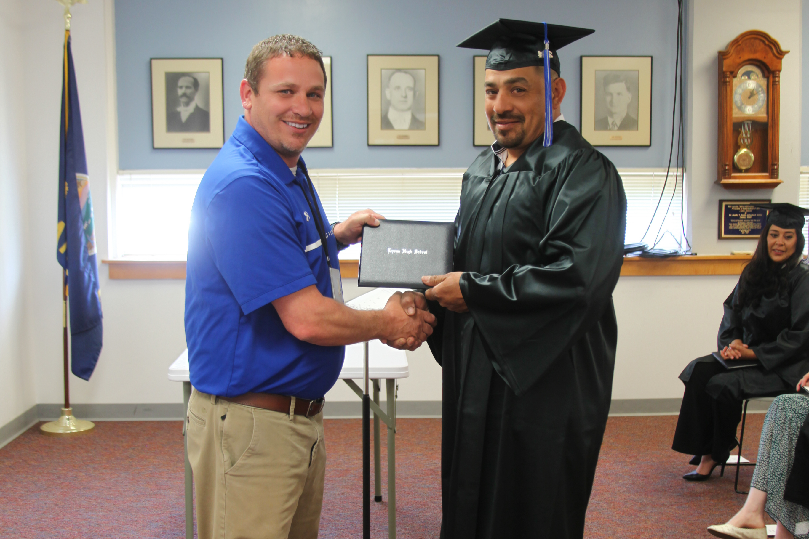 Mr. Carlson delivering diploma to 2024 Graduate Jose Reyes