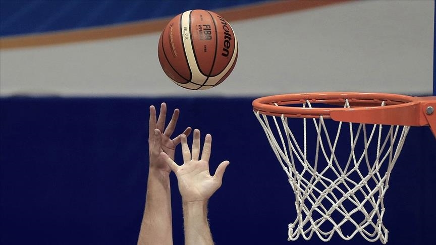 Hands reaching for basketball. 