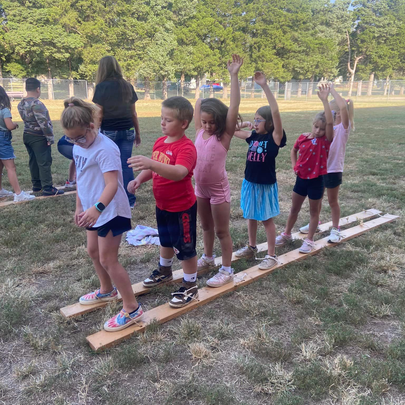 Students working together to move long skis