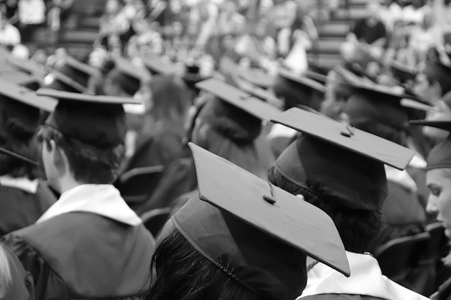 Black and white photo of graduating seniors wearing their hats