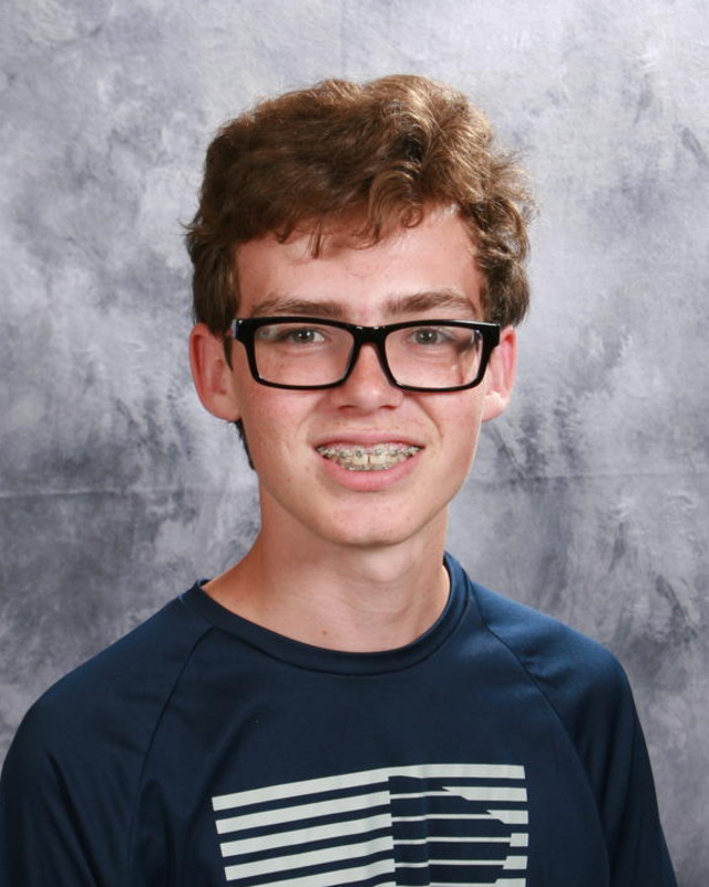 smiling teenage boy with glasses and braces