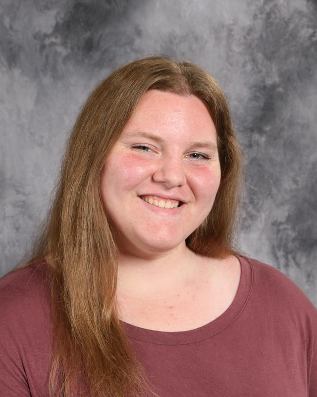 smiling teenage girl with long blonde hair