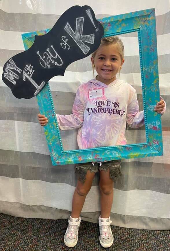 Image of little girl holding "My 1st Day of K" sign