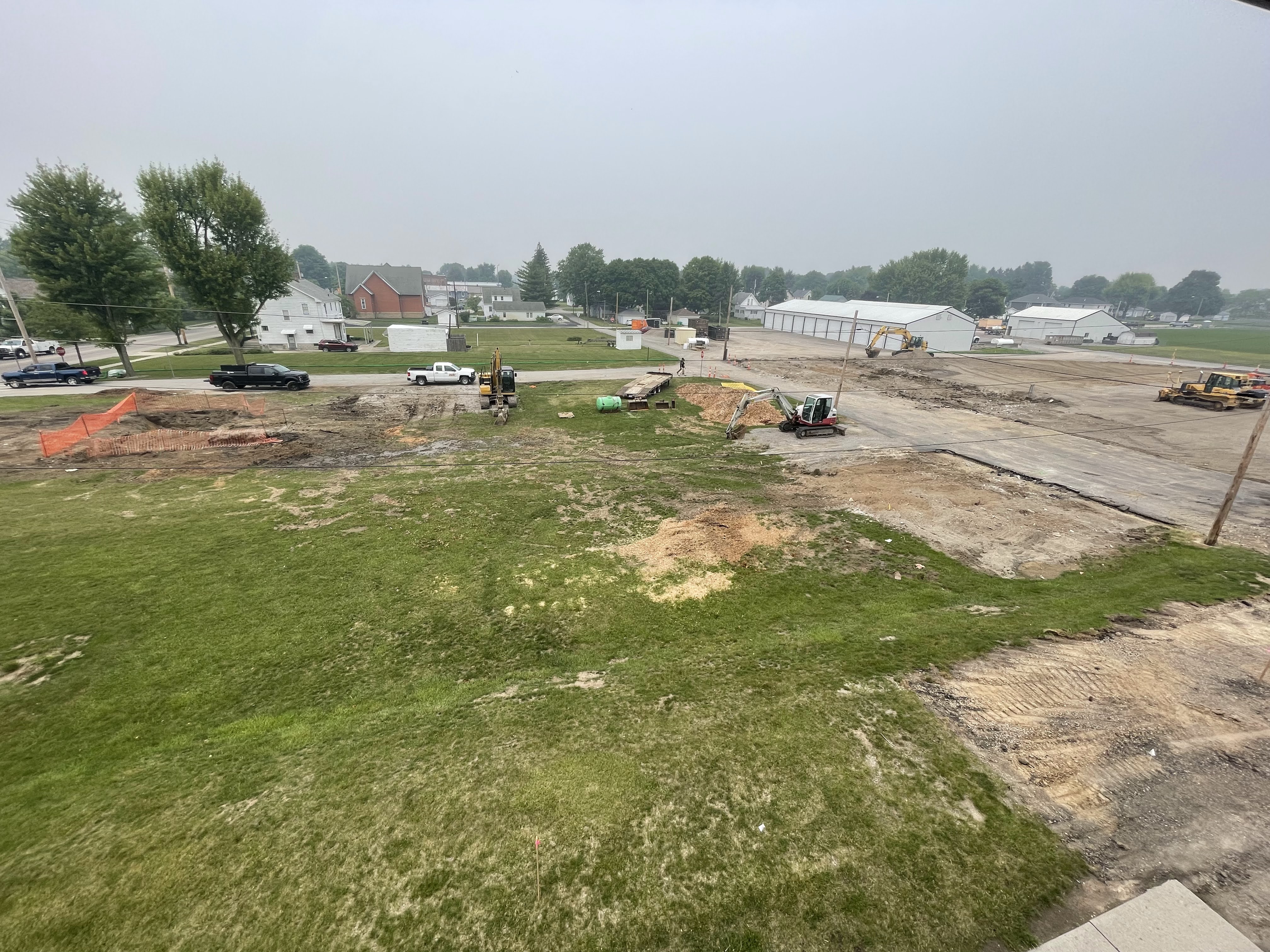 "Birds-eye view" of grass lot with maintenance building, garage, house and shed removed