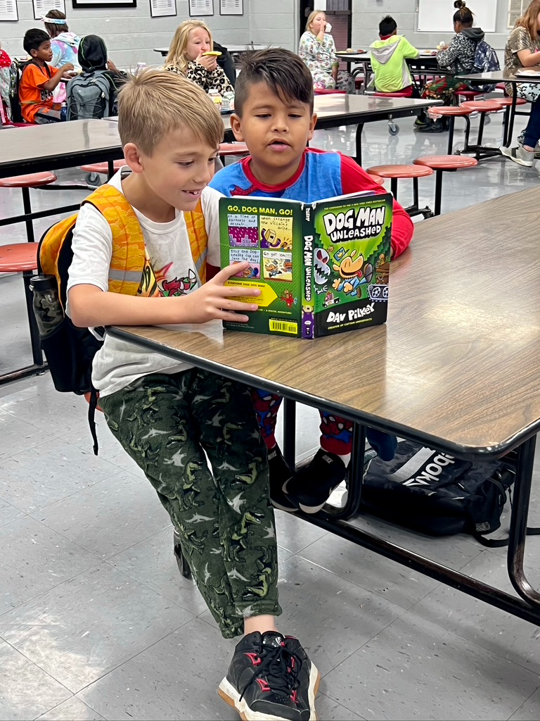 Students reading a book together