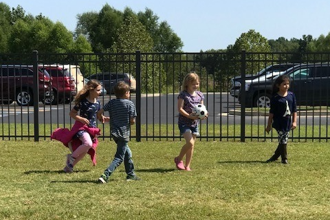 children play kickball on Paragould Primary lawn