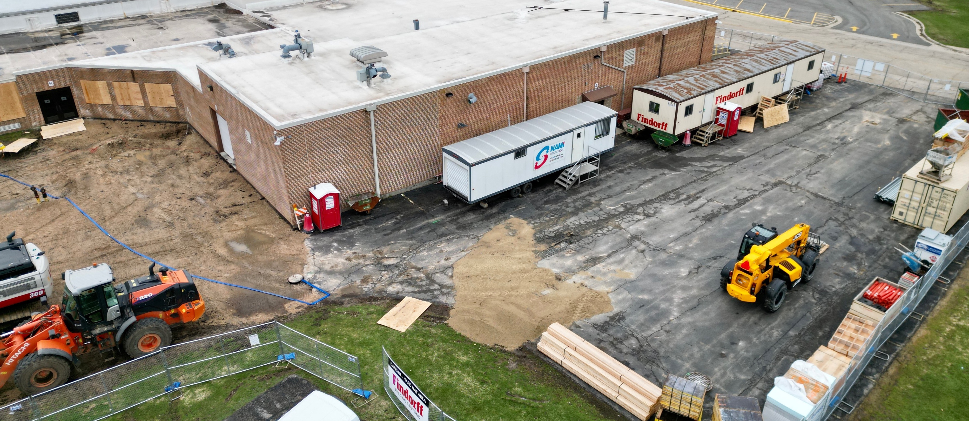 New construction to the Tech Ed wing, including heavy equipment, sand, and building materials. 