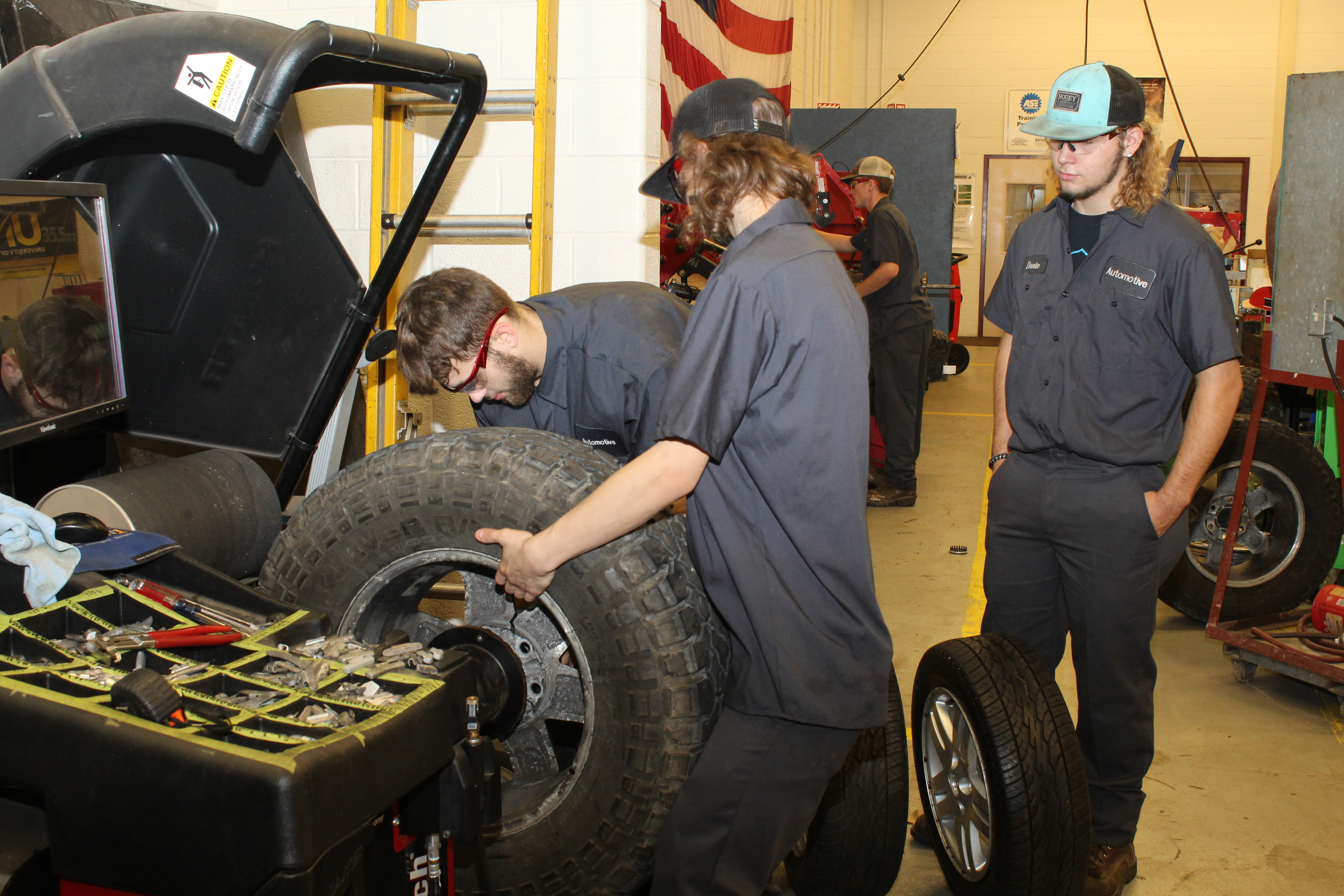 Students work on a late model project car.