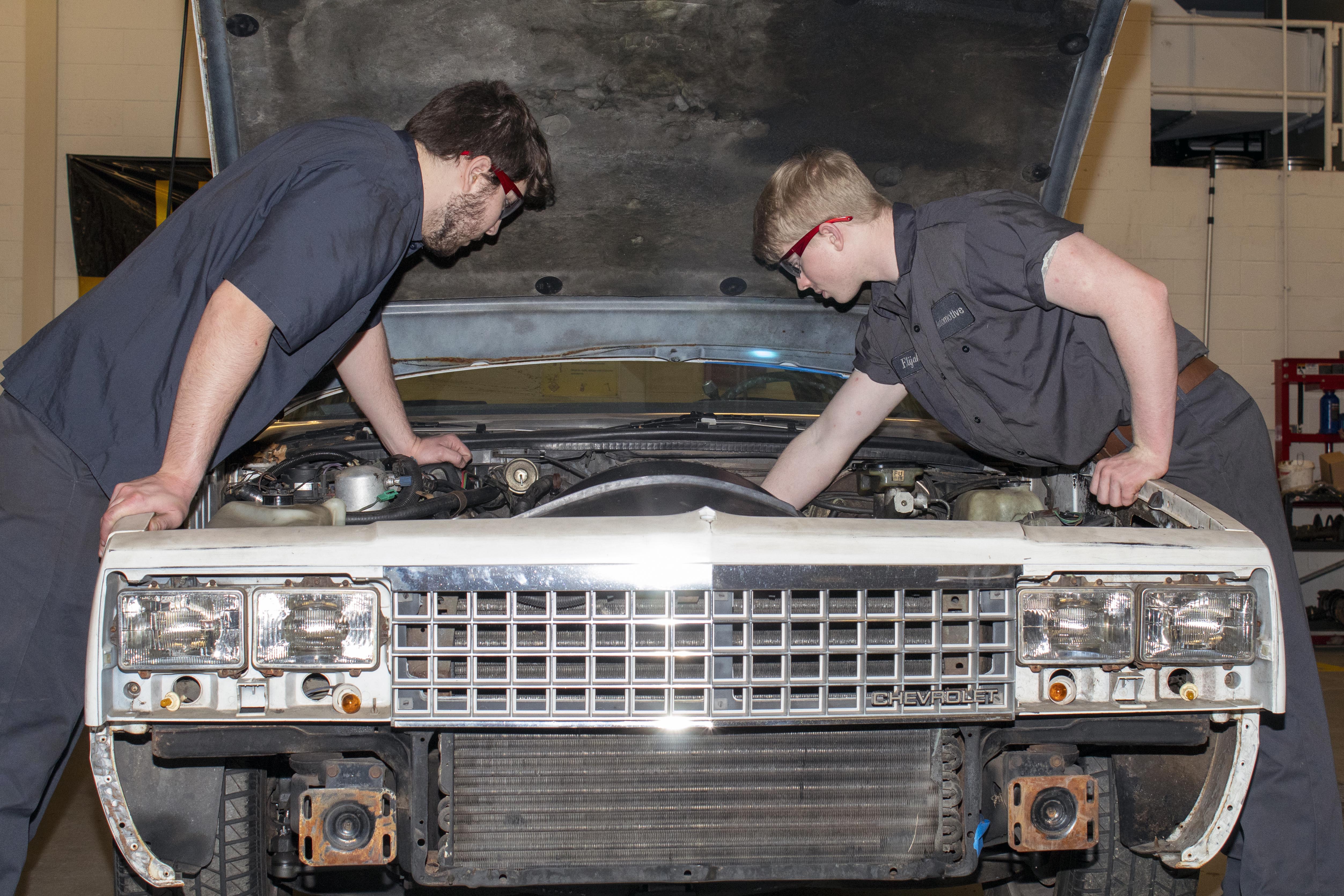 Students work on a late model project car.