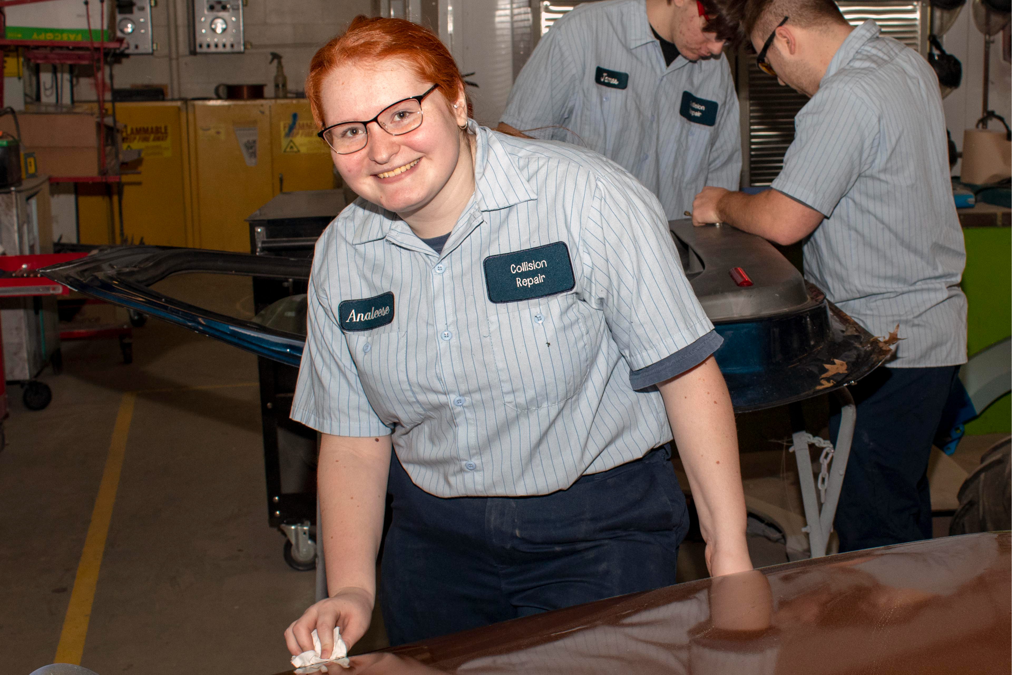 A student puts finishing touches on a freshly painted panel.