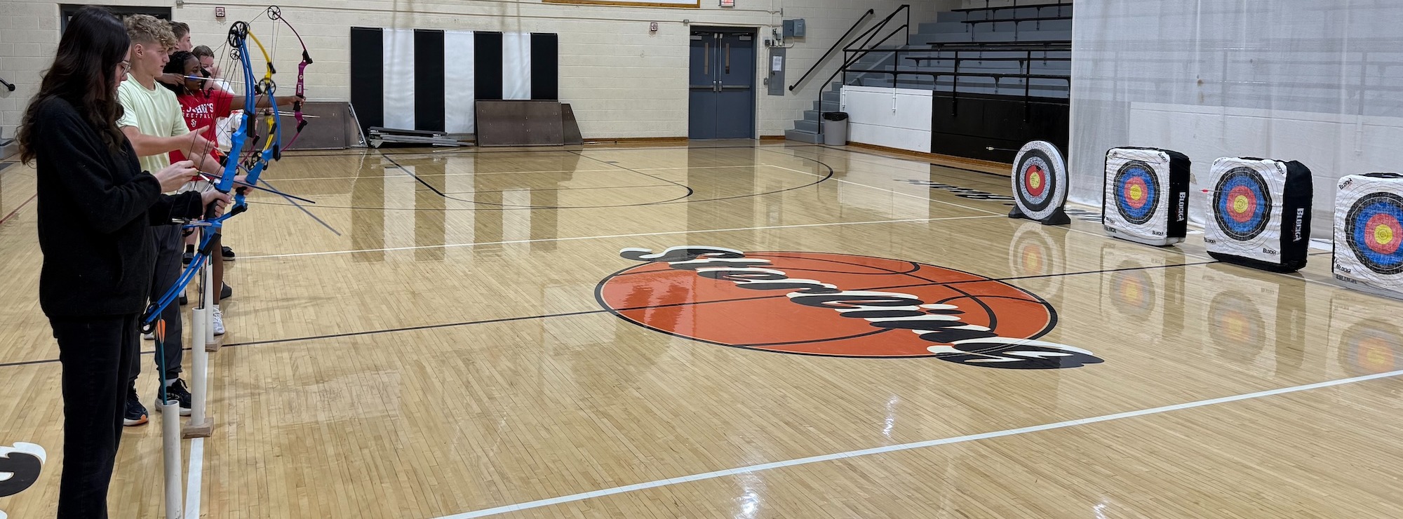 SJSHS students learning archery with Mrs. Normandin.