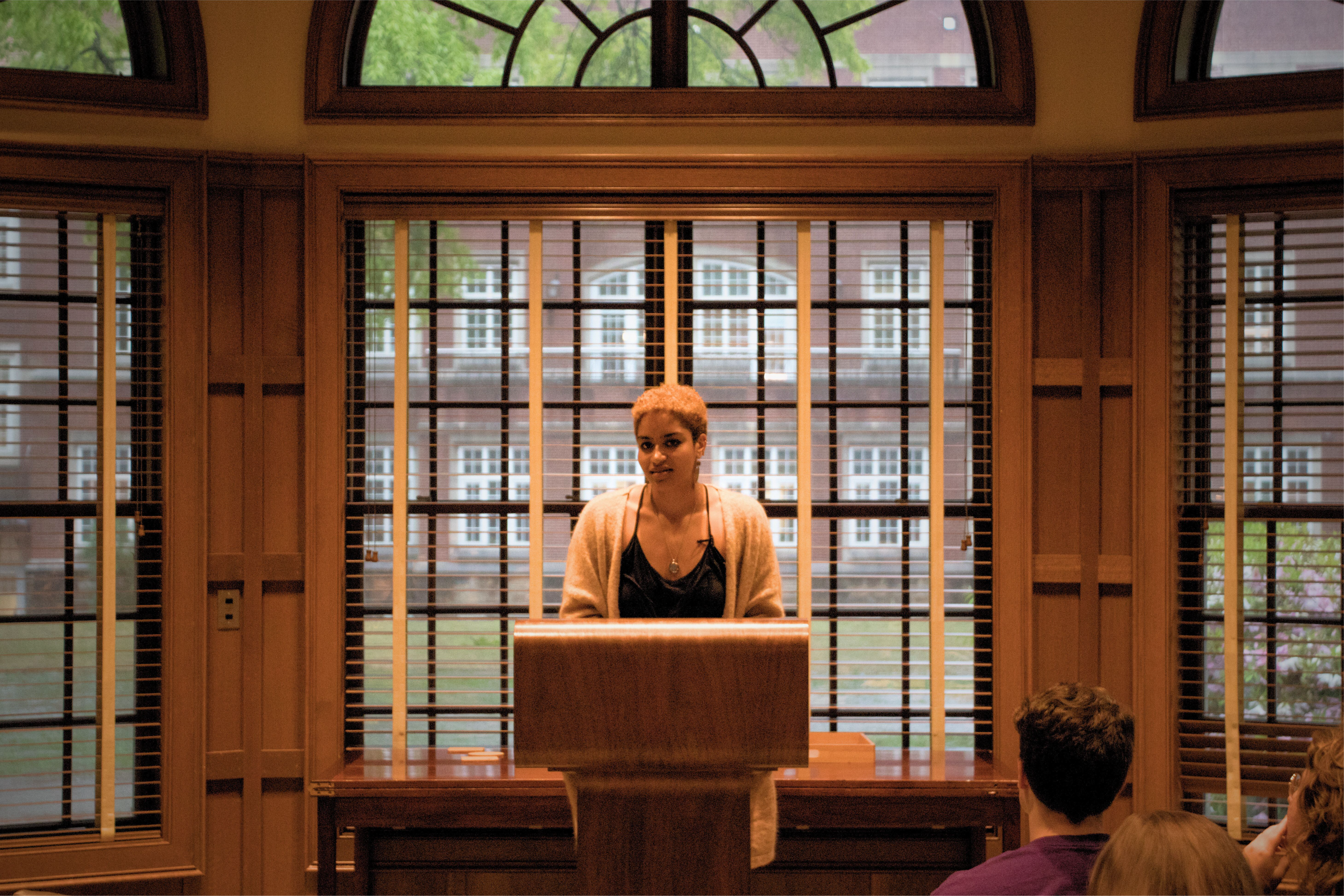 student reading at a podium at Word Garden